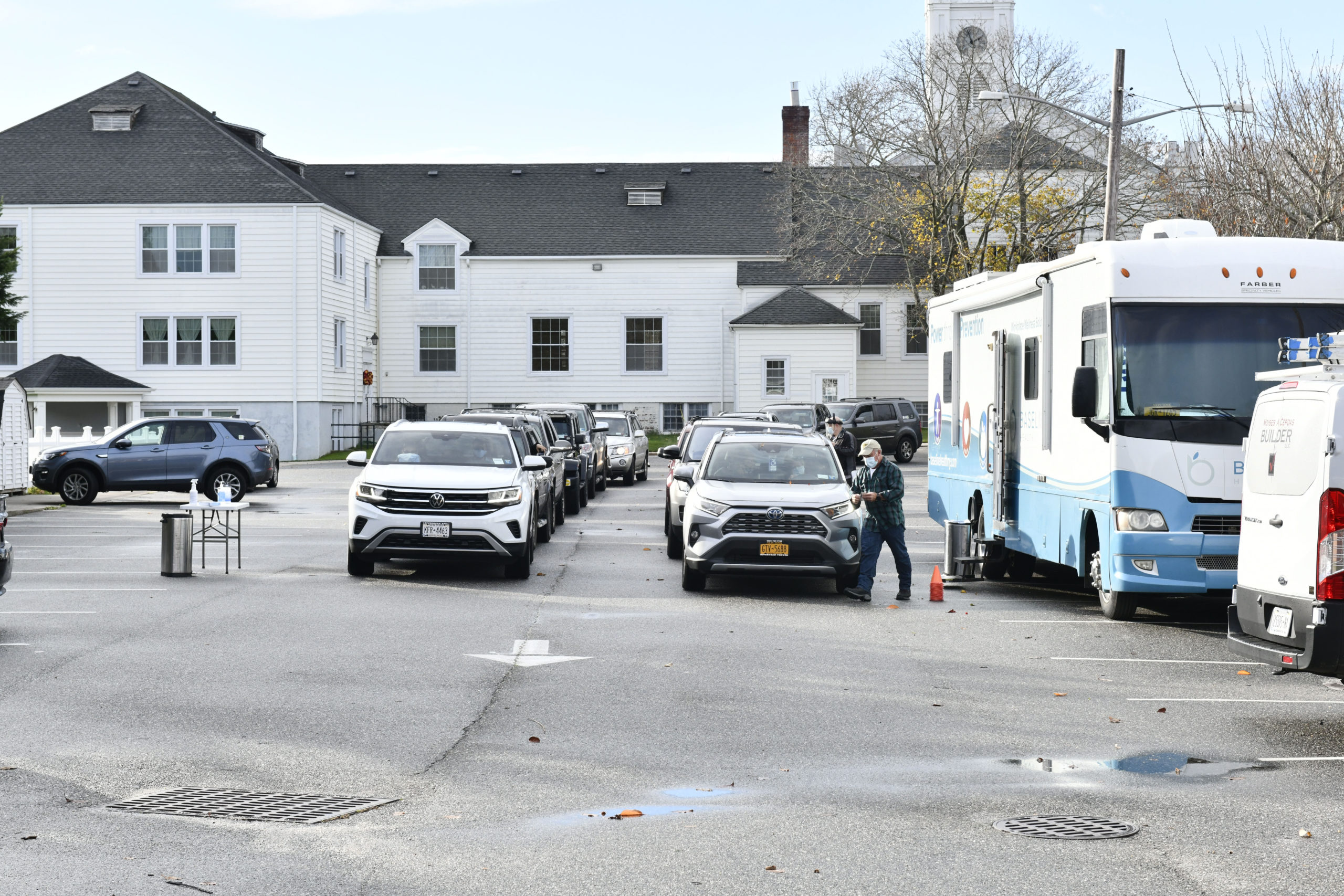 Cars line up for mobile COVID testing in the parking lot of the First Presbyterian Church in Southampton Village .      DANA SHAW
