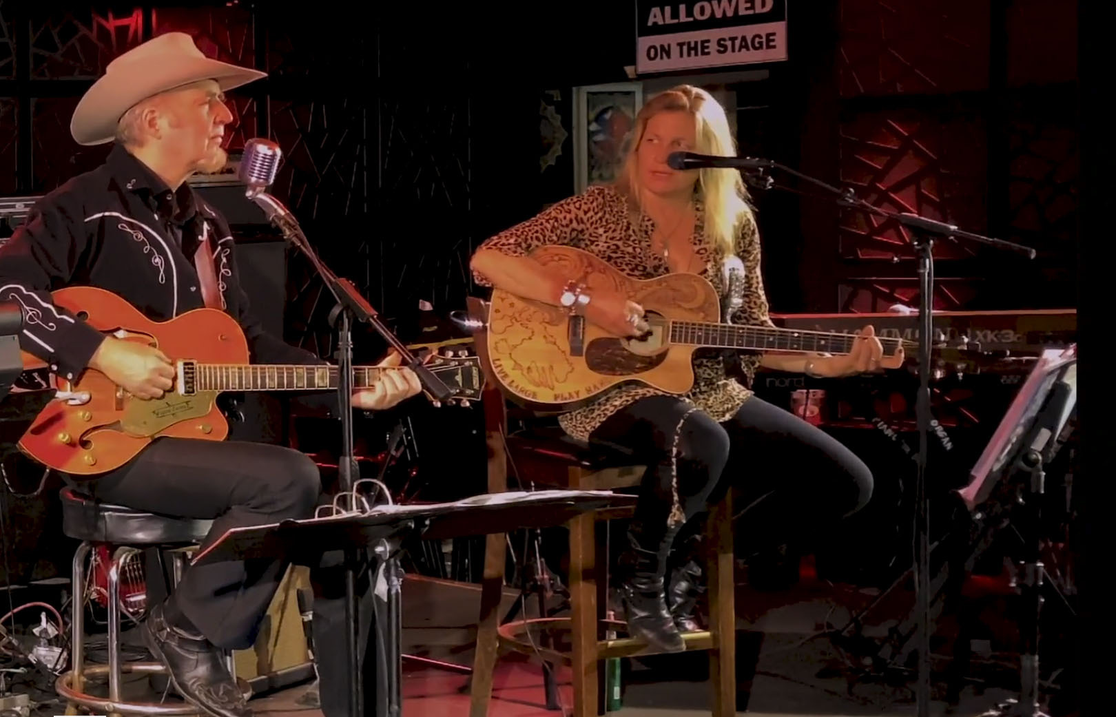 Gene Casey and Nancy Atlas performing on The Stephen Talkhouse stage in a still image from an upcoming episode of Friday Night Hustle.