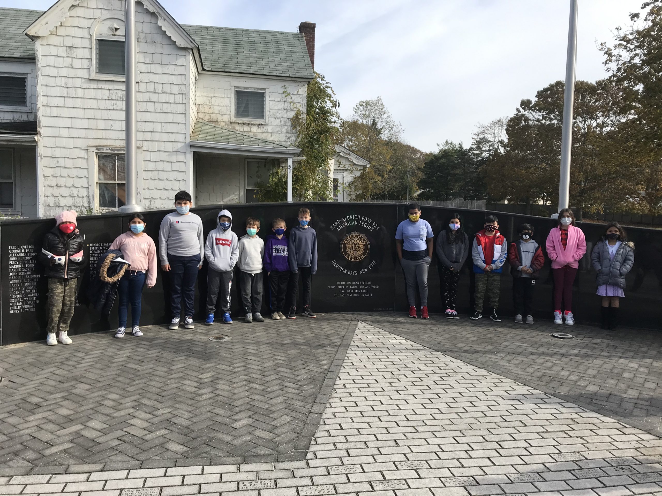 As part of a Veterans Day celebration, fourth grade students at Hampton Bays Elementary School took a walking field trip to the community’s veterans memorial at the American Legion Post 924 on Ponquogue Avenue. Students learned more about the memorial and spent time speaking with local veterans.