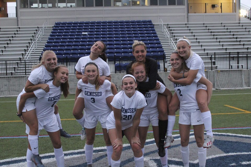 McKinley Skala, on piggy back, far right, with her SUNY Geneseo women’s soccer teammates last year. This year, as a sophomore, she’s been dealing with a cancelled fall season and hoping the team can play in the spring. 