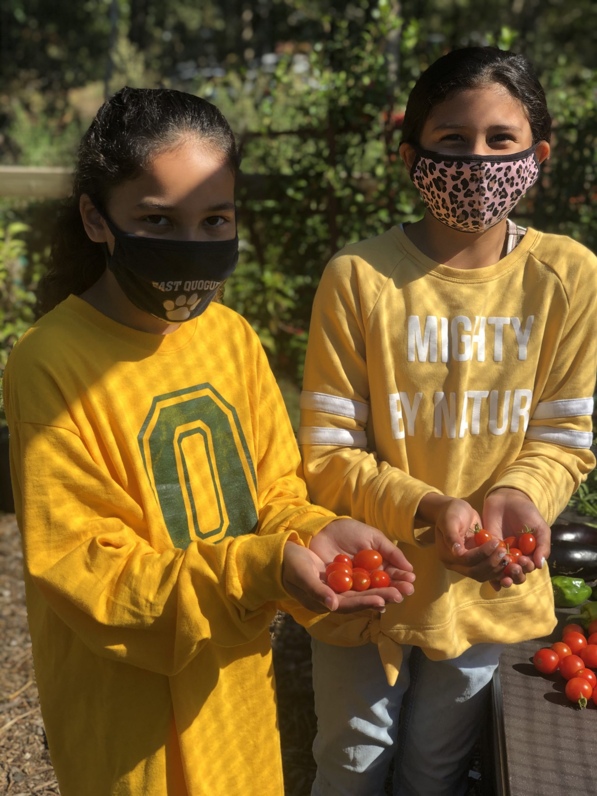 Aurora Recchion and Gabriela Cisneros enjoy learning in the Quogue Elementary School garden last week, where Mrs. Kelly Zaffuto’s class spent time journaling. 