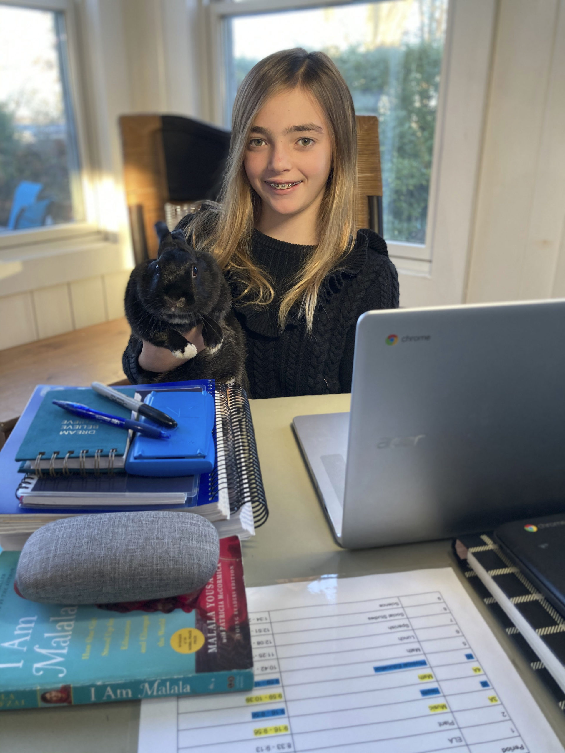 Pierson Middle School seventh-grader Sabrina McManus often has a furry companion--her rabbit, Amelia--by her side when she is engaged in remote learning at home. 