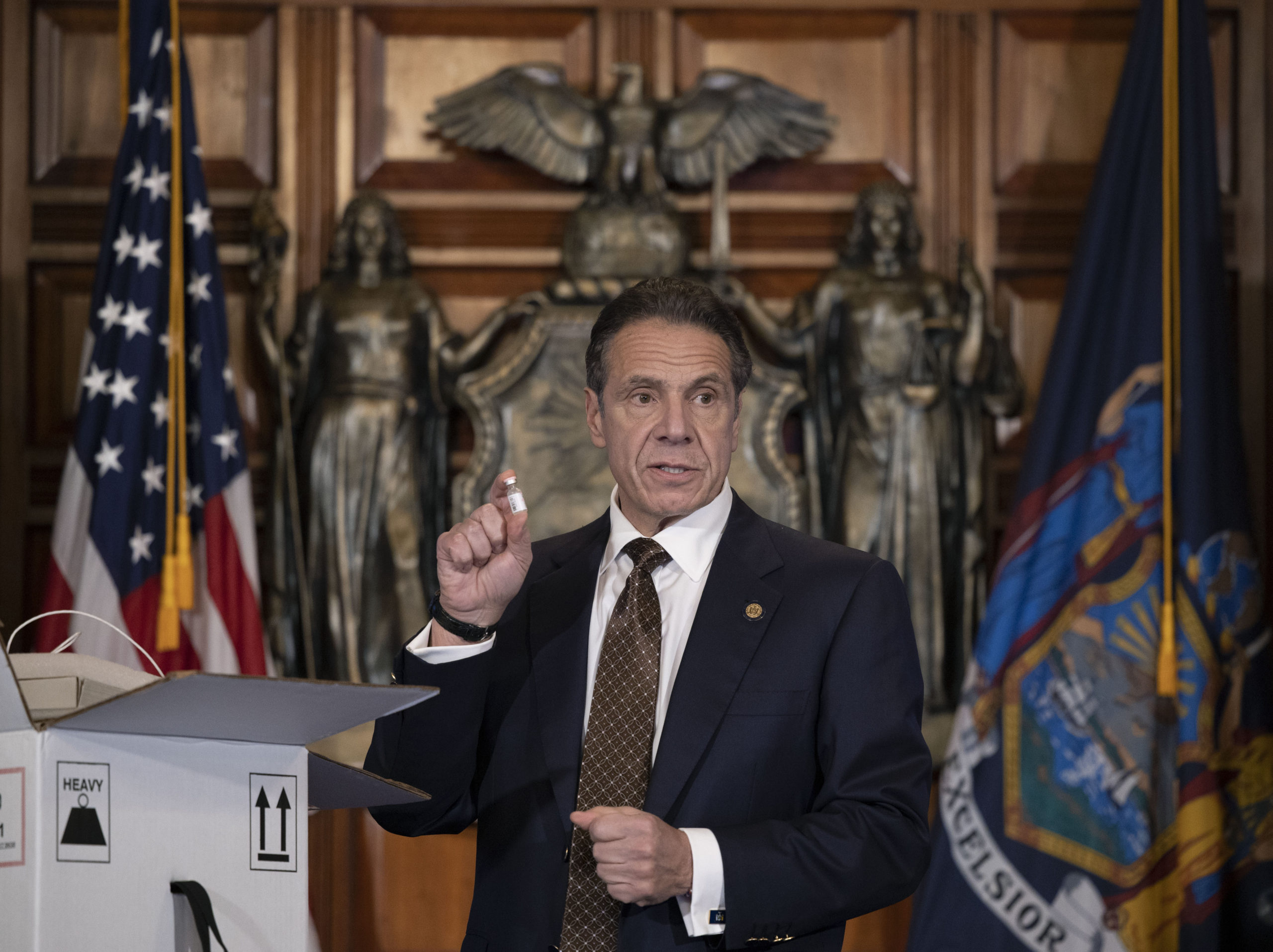 Governor Andrew Cuomo with an example of the cold storage box that the vaccine will be shipped in and a vial of the vaccine. MIKE GROLL/OFFICE OF GOVERNOR ANDREW M. CUOMO 