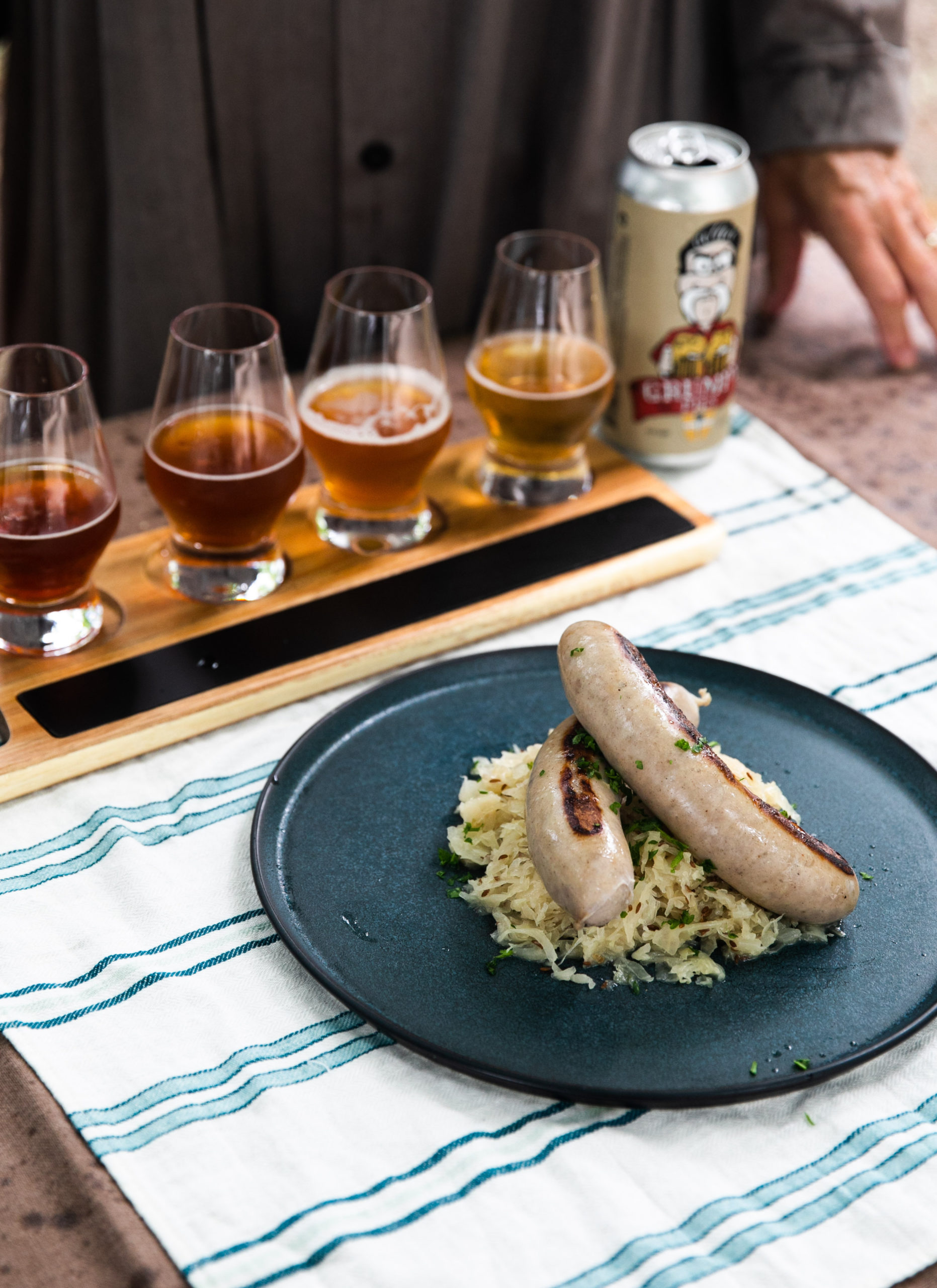 Bangers with beer braised sauerkraut is one of the recipes in the February book from the Loaves & Fishes Farm Series.