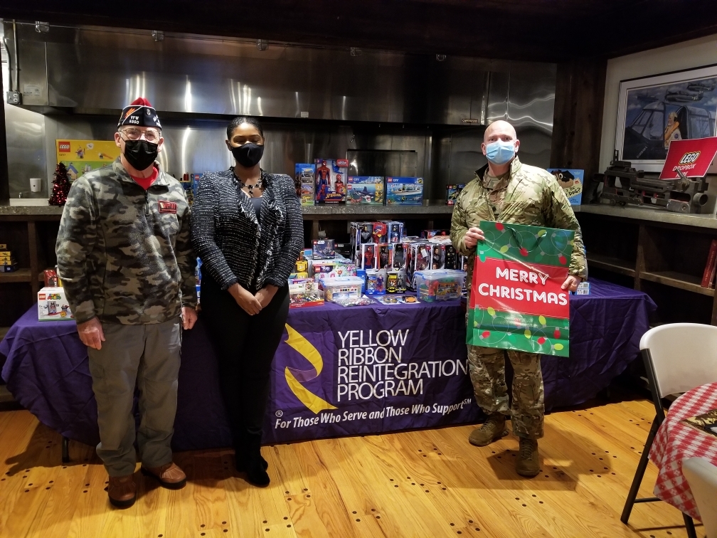 (Left to right) Westhampton Beach VFW Post 5350 Commander William Hughes, Yellow Ribbon Specialist and VFW Member Ebonnie Goodfield and Lt. Colonel Chris Baker at a Christmas Grab gift event held on December 4 and December 5 for military personnel. Many toys were donated by Turner Construction Inc. for the event, which was initiated by Ms. Goodfield. 
