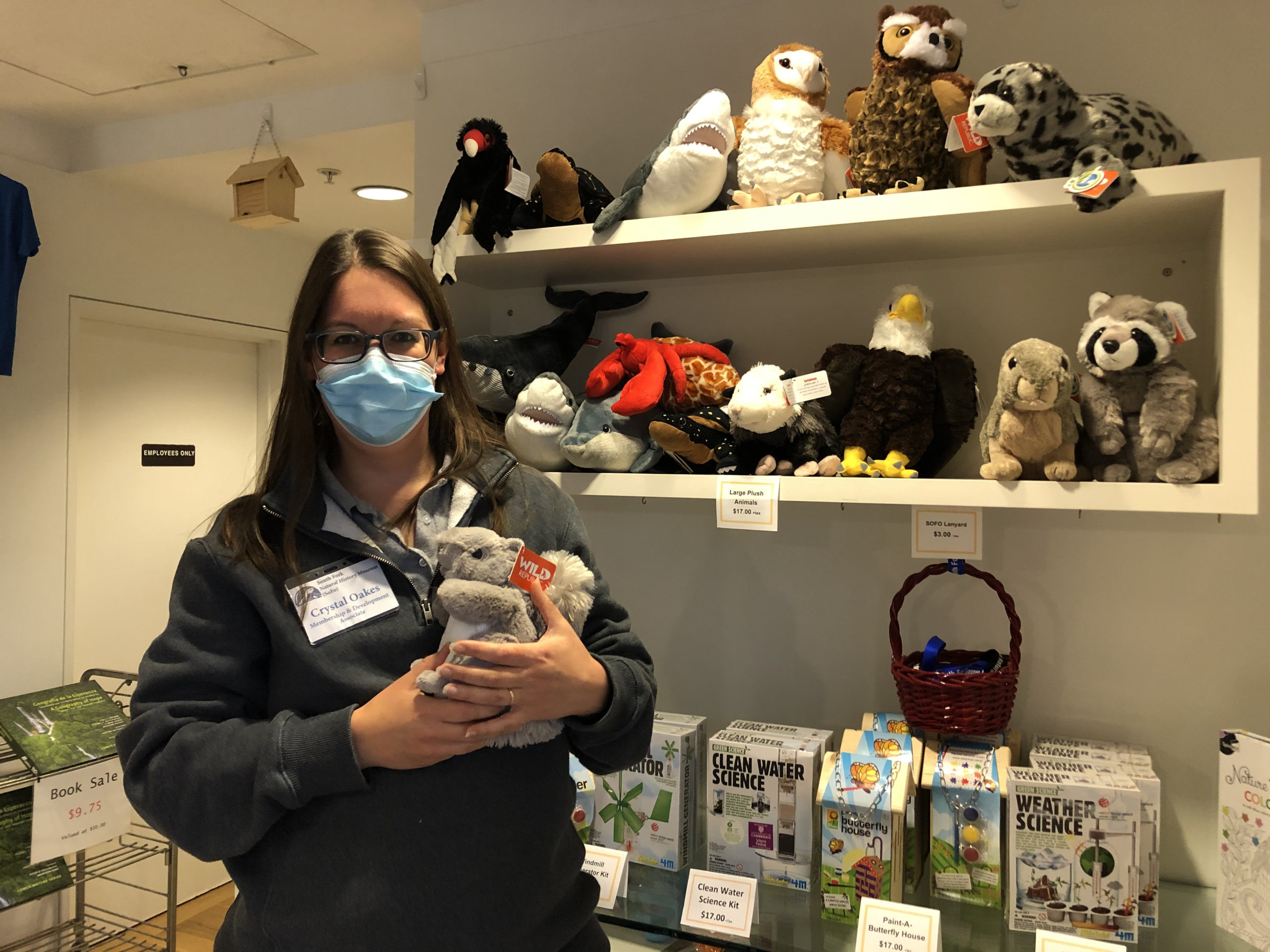 Crystal Possehl-Oakes with environmental-themed gifts at the South Fork Natural History Museum.