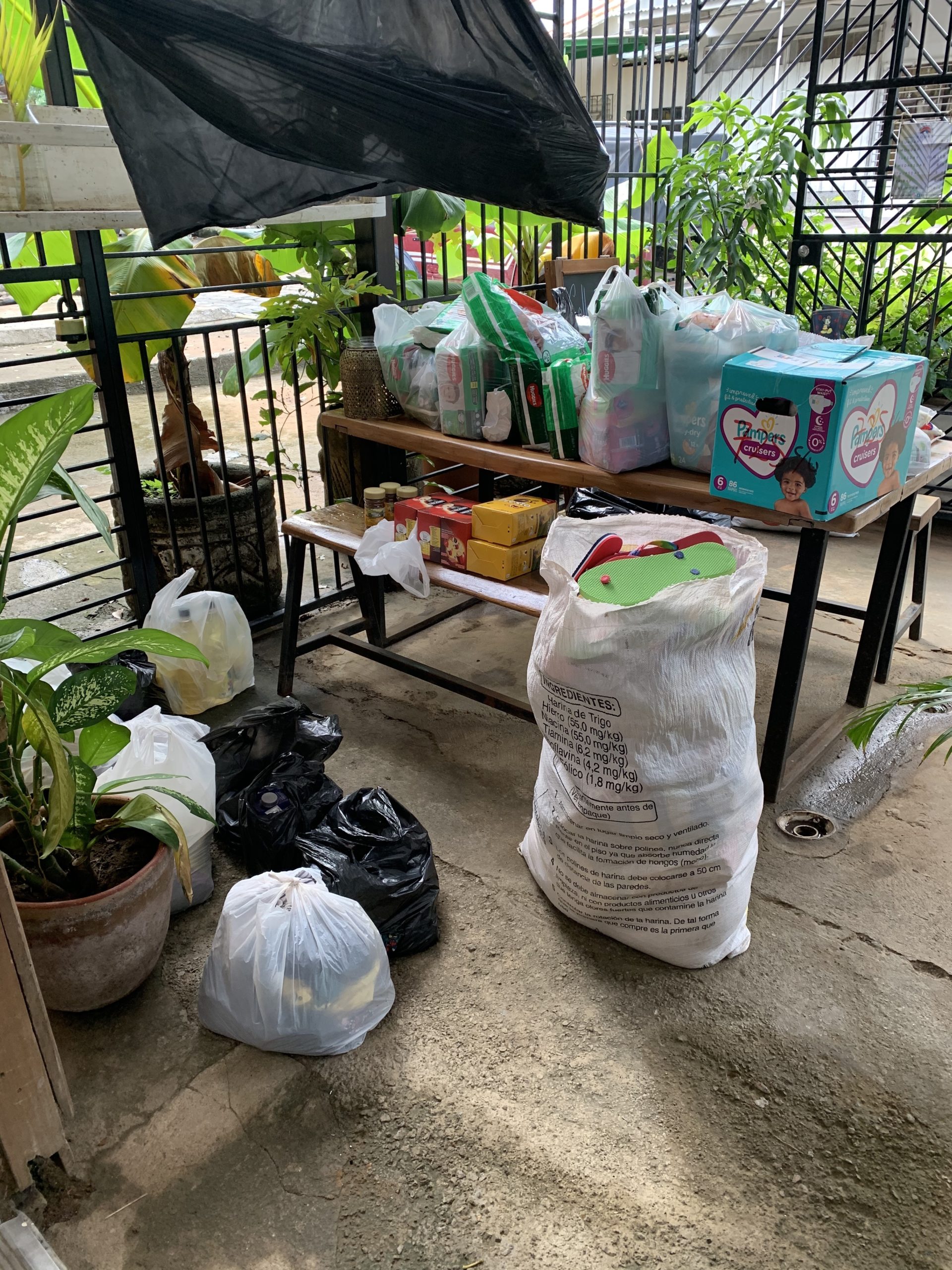 Volunteers from different communities help divide and repackage donations before distributing them to neighborhoods destroyed by hurricane flooding and high winds in Nicaragua.
