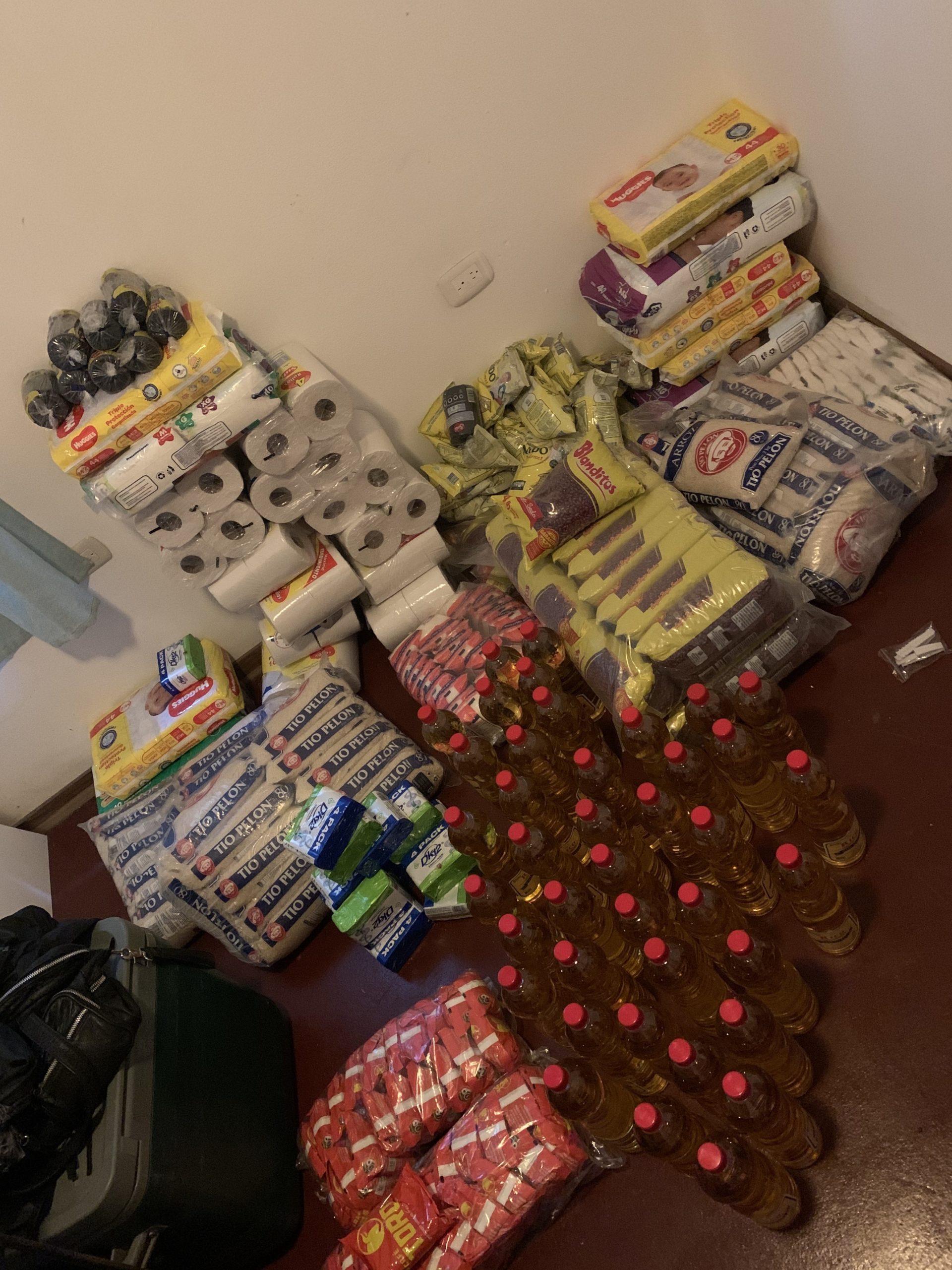 Volunteers from different communities help divide and repackage donations before distributing them to neighborhoods destroyed by hurricane flooding and high winds in Nicaragua.