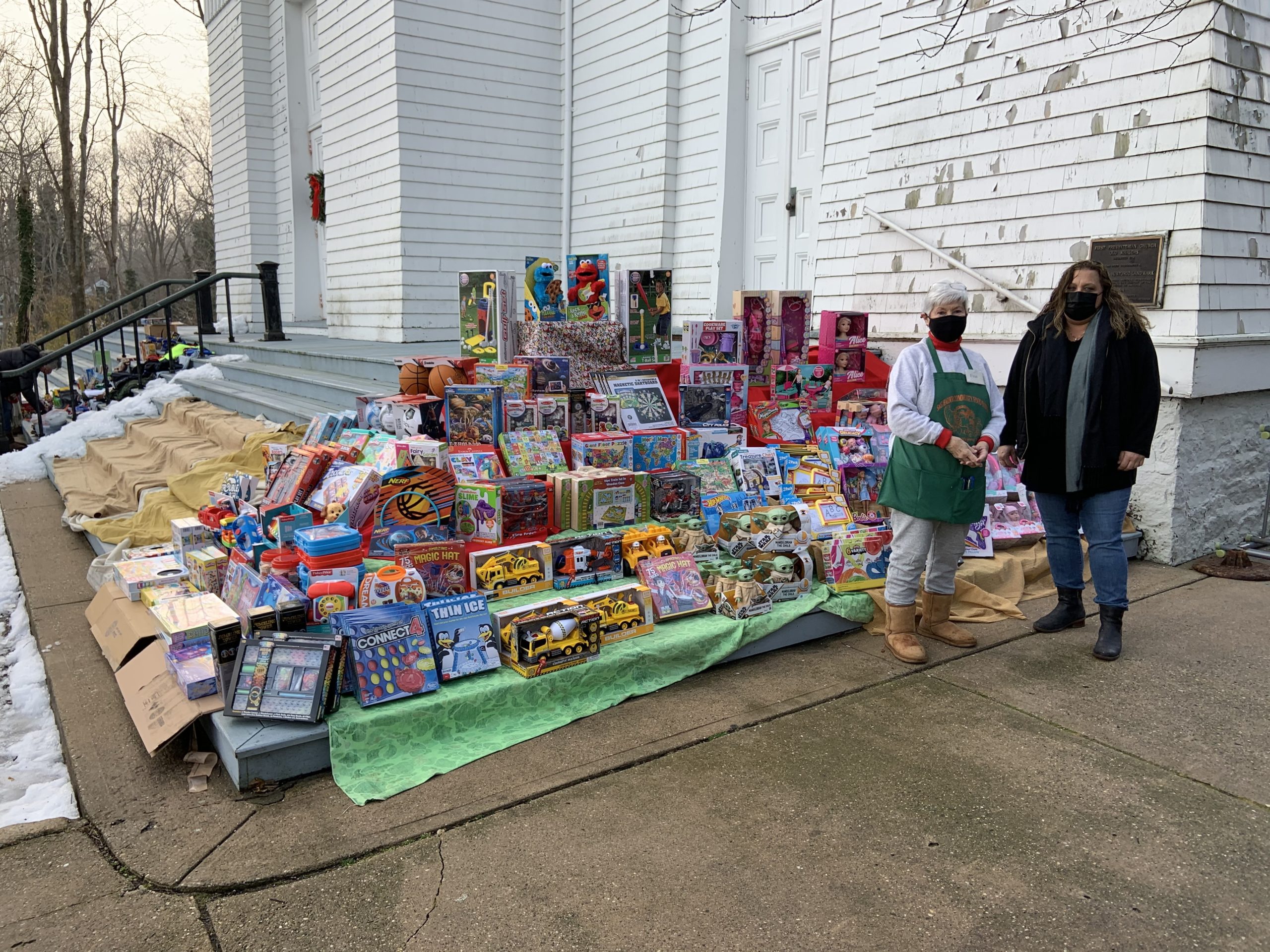 Thanks to an anonymous donor, clients of the Sag Harbor Food Pantry were able to select a gift for their children on Tuesday.  Food pantry director Evelyn Ramunno and Lisa Field of the Sag Harbor Variety Store, who facilitated the donation, stand with the bounty. STEPHEN J. KOTZ