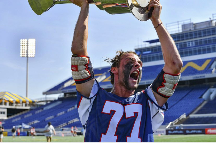 Boston Cannons defender Justin Pugal, an Eastport-South Manor graduate, raises the 2019 Major League Lacrosse championship trophy over his head in celebration.   PHOTO COURTESY JUSTIN PUGAL