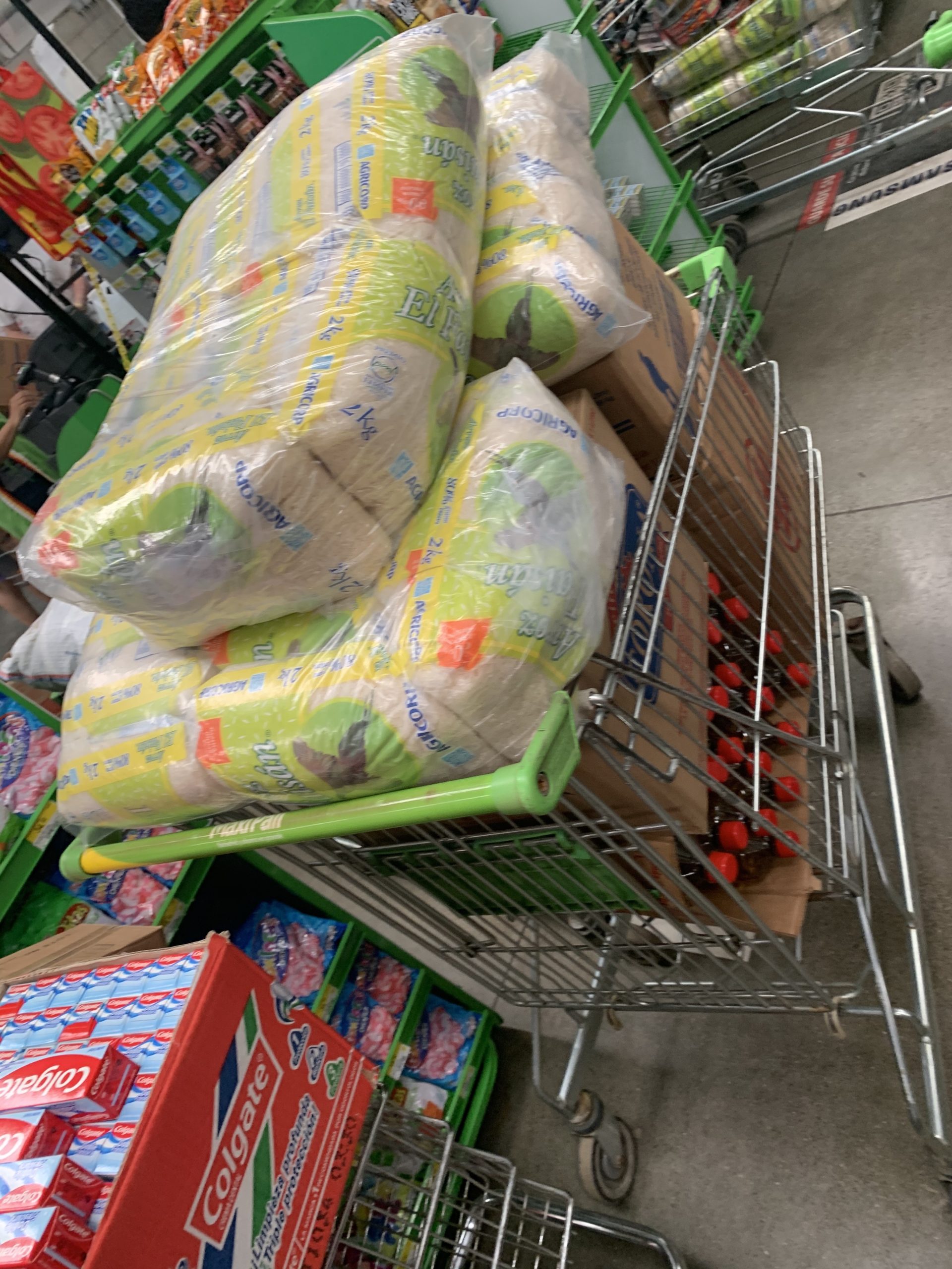 Volunteers from different communities help divide and repackage donations before distributing them to neighborhoods destroyed by hurricane flooding and high winds in Nicaragua.