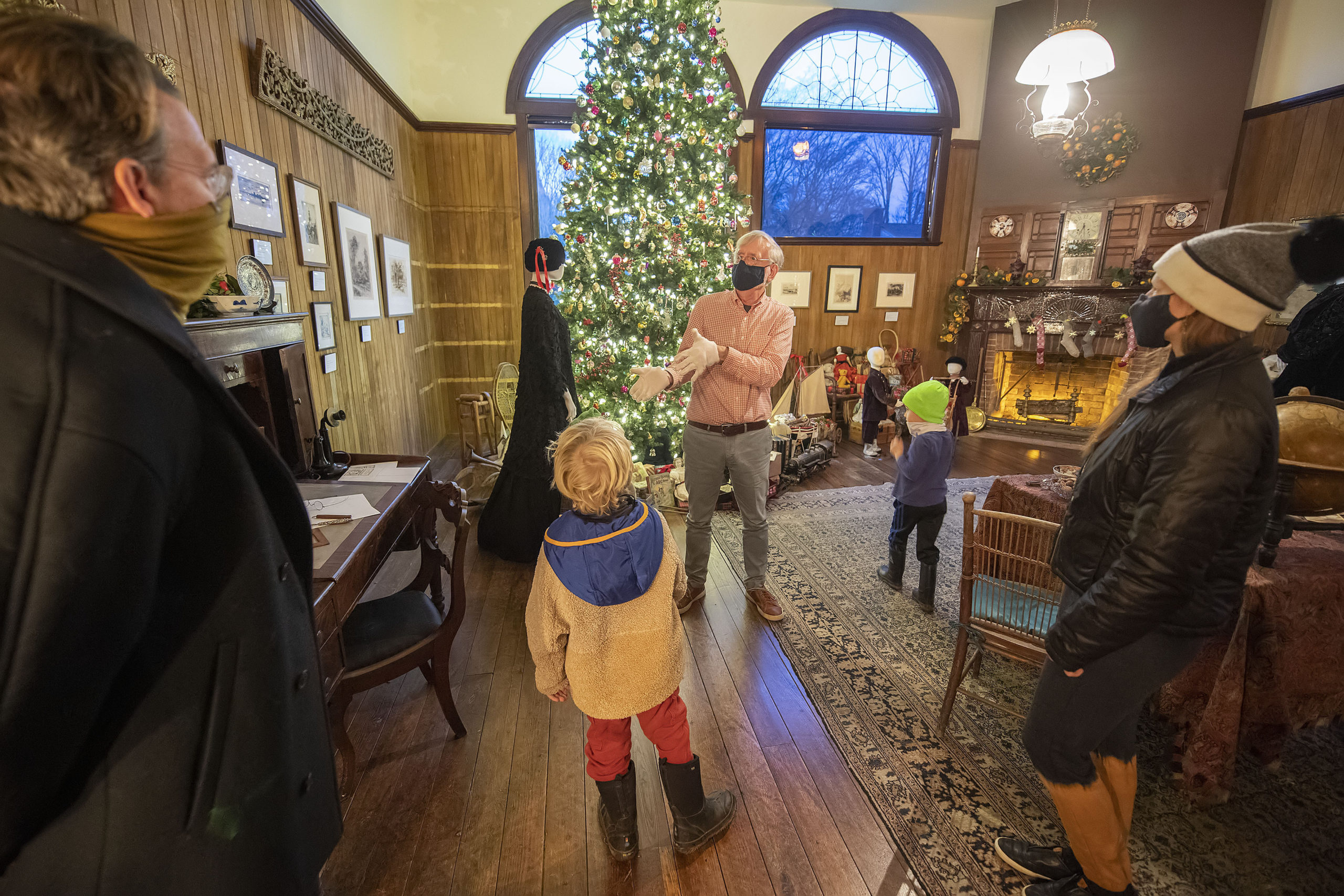Curator Richard Barons leads a family on a socially-distanced tour of the Moran House, decorated for Christmas by the East Hampton Historical Society as it could have been in the late Victorian period, circa 1884. MICHAEL HELLER 