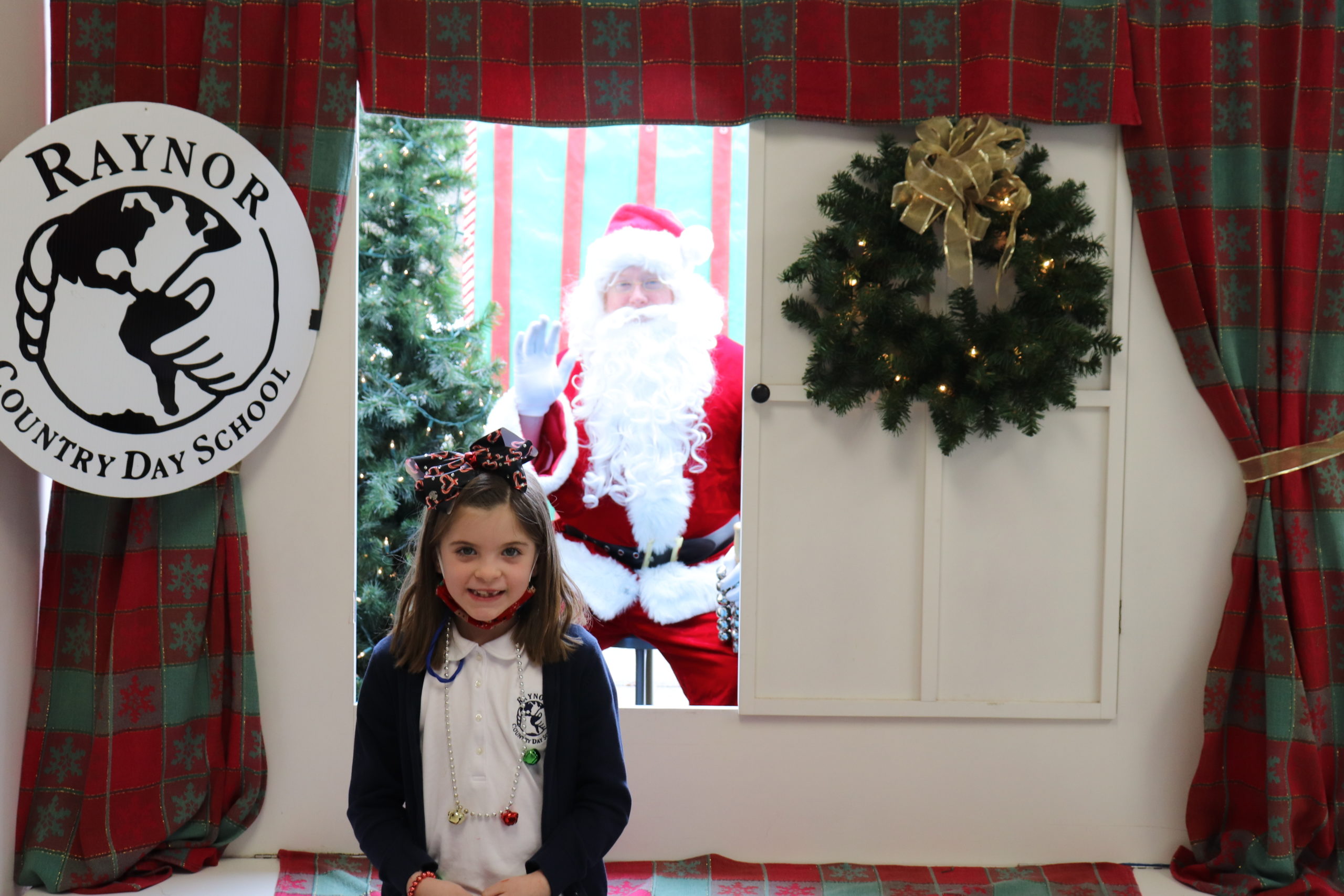 First-grade student, Keira Raymond, is all smiles after meeting with Santa at Raynor Country Day School's annual Holiday Festival.