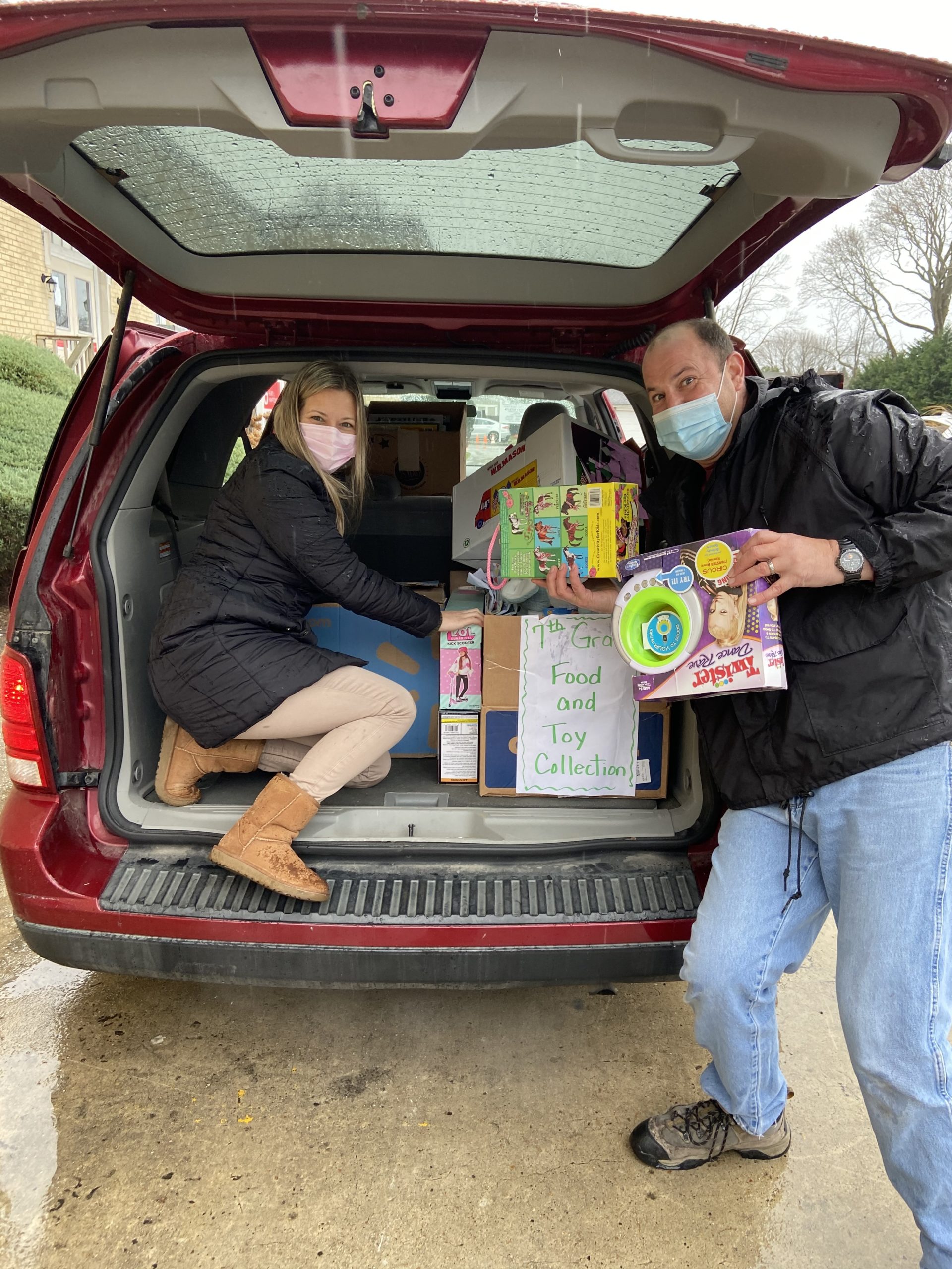 Tuckahoe school custodian Christopher Capalbo helps fifth grade teacher Hillian Cagno with food and toy drive items collected by members of the Tuckahoe school community and members of the National Junior Honor Society and Student Council which donated over 700 items to Heart of the Hamptons.