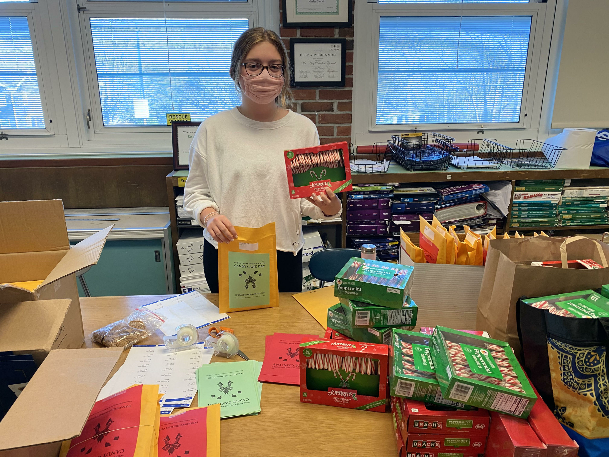 To generate holiday spirit among students and faculty, members of the Westhampton Beach High School National Honor Society generously donated enough candy canes for every student and teacher in the building. The candy canes will be distributed during the week of December 21. Pictured is National Honor Society treasurer Jane Paulson. 