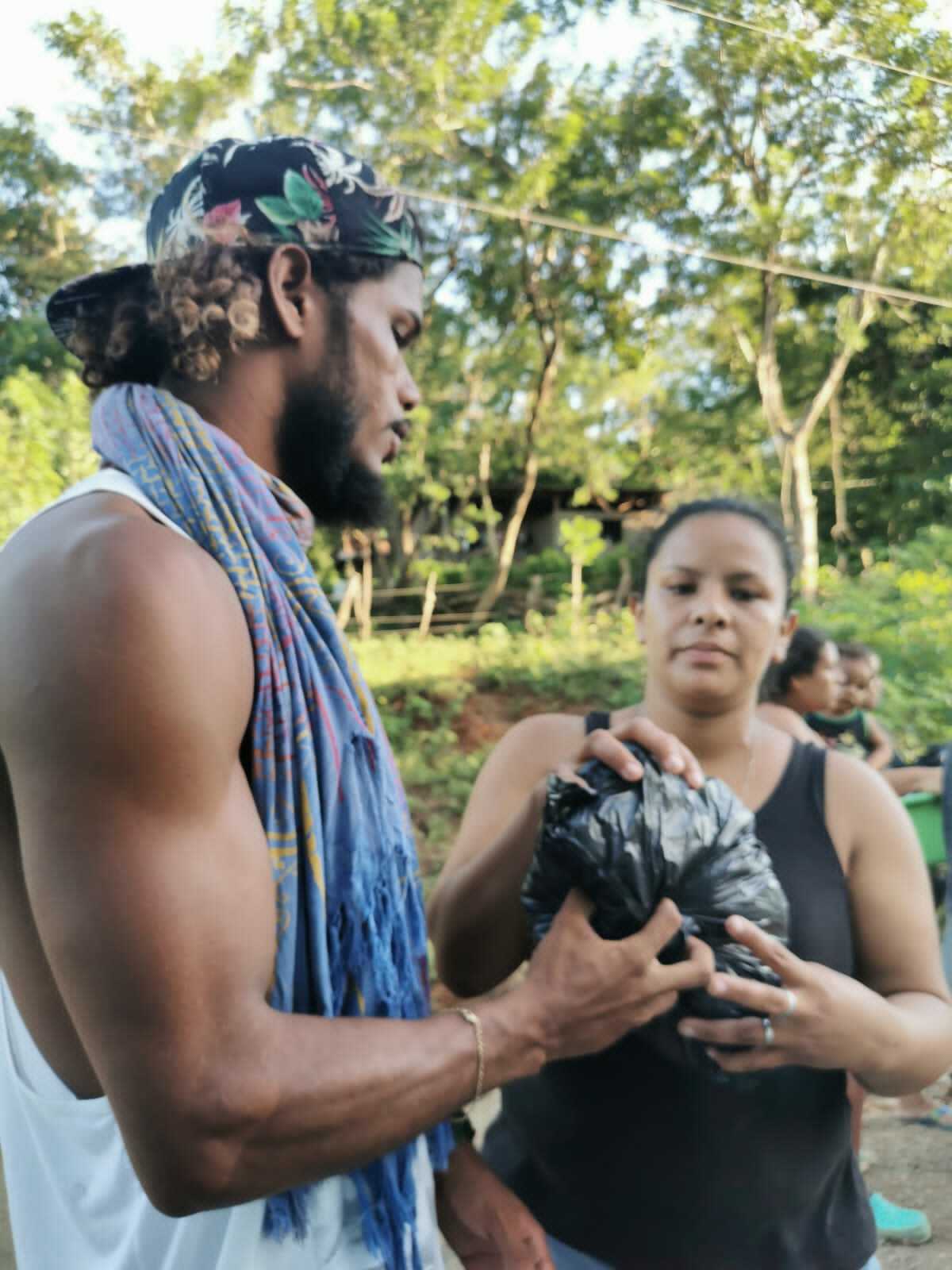 Volunteers from different communities help divide and repackage donations before distributing them to neighborhoods destroyed by hurricane flooding and high winds in Nicaragua.