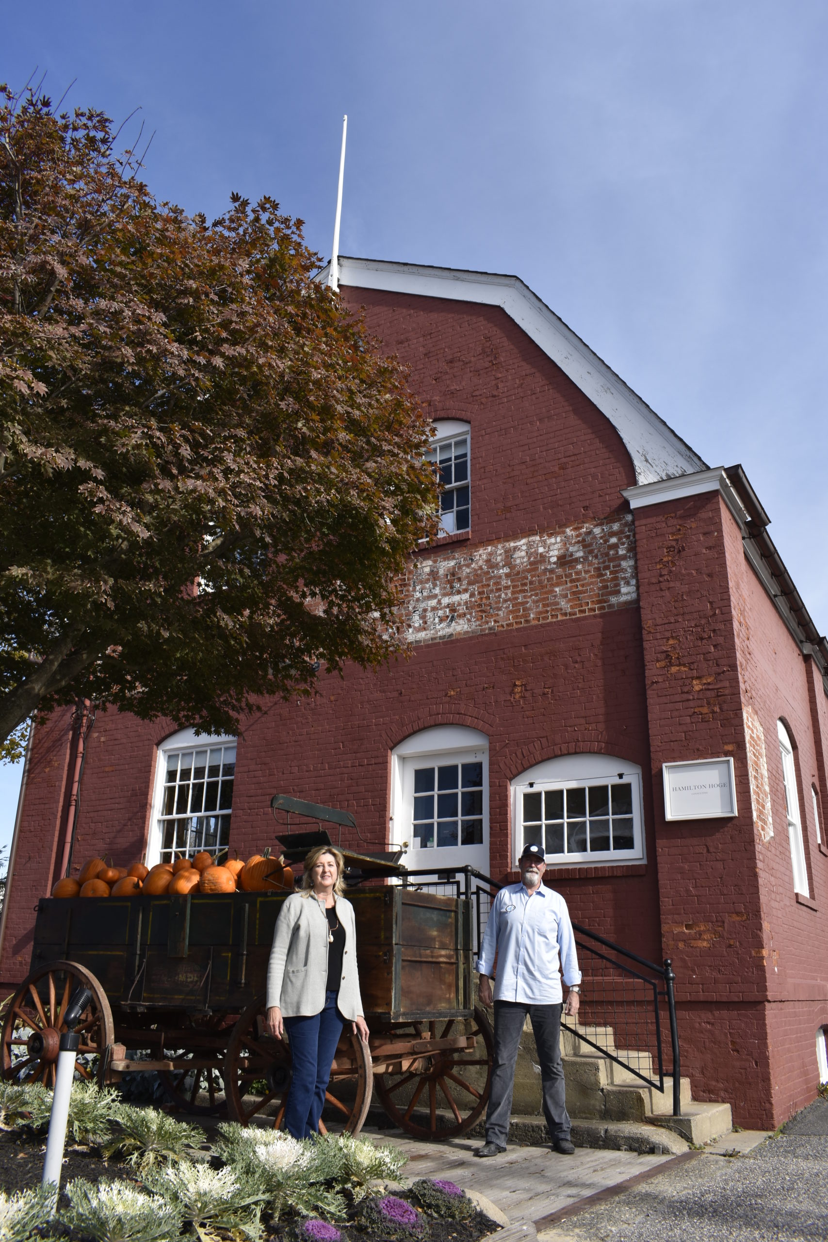 Karen and Stuart Andrews at 7 Powell Avenue with a historic wagon on the building's wagon scale.