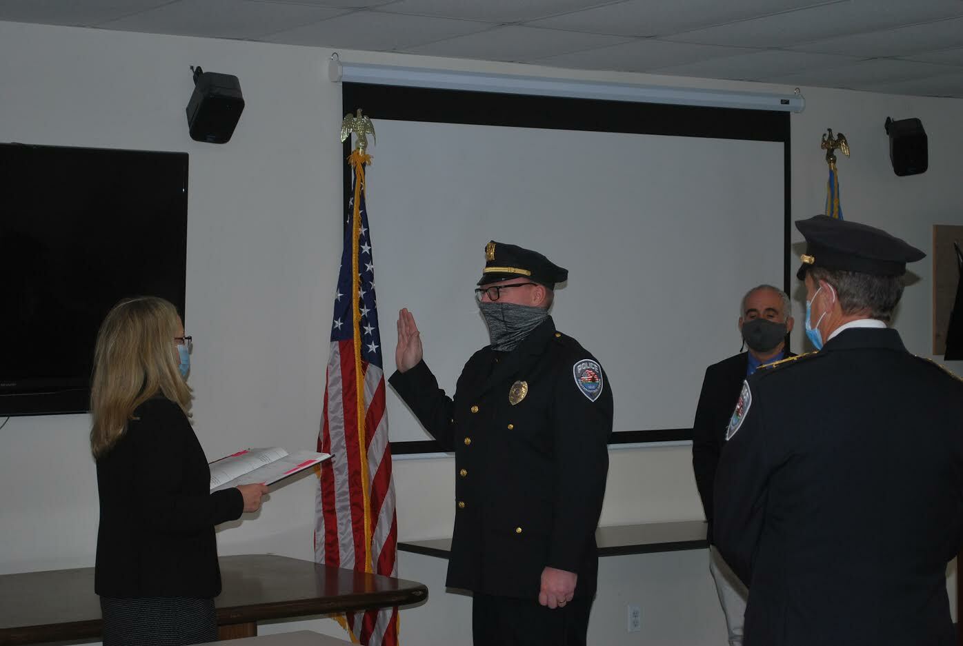 Town Clerk Sundy Schermeyer swears in Howard Kalb, promoting the sergeant to the rank of lieutenant in the Southampton Town Police Department. COURTESY STPD