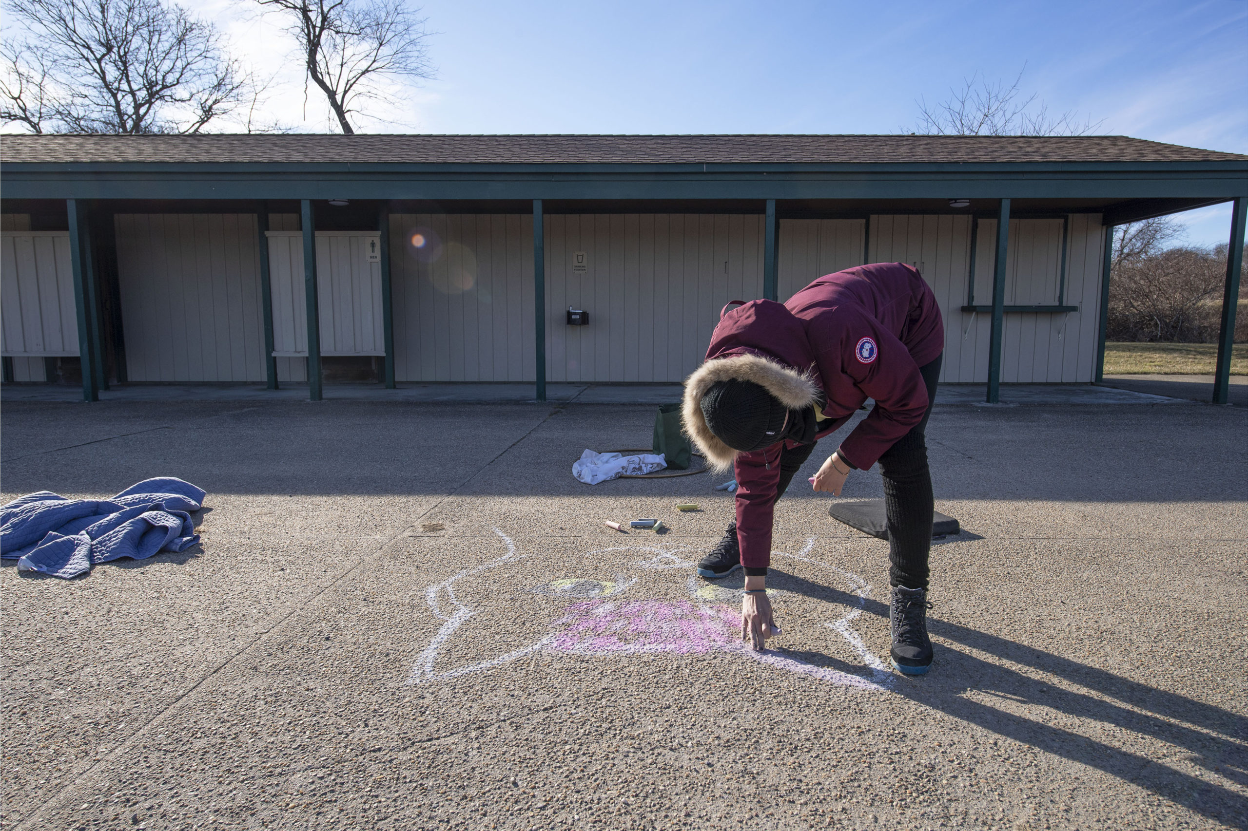 Becca Wilson drove from Hampton Bays to participate during a chalk-drawing get-together hosted by Kate Mueth and the Neo-Political Cowgirls at the Third House grounds in Montauk on Sunday.   MICHAEL HELLER