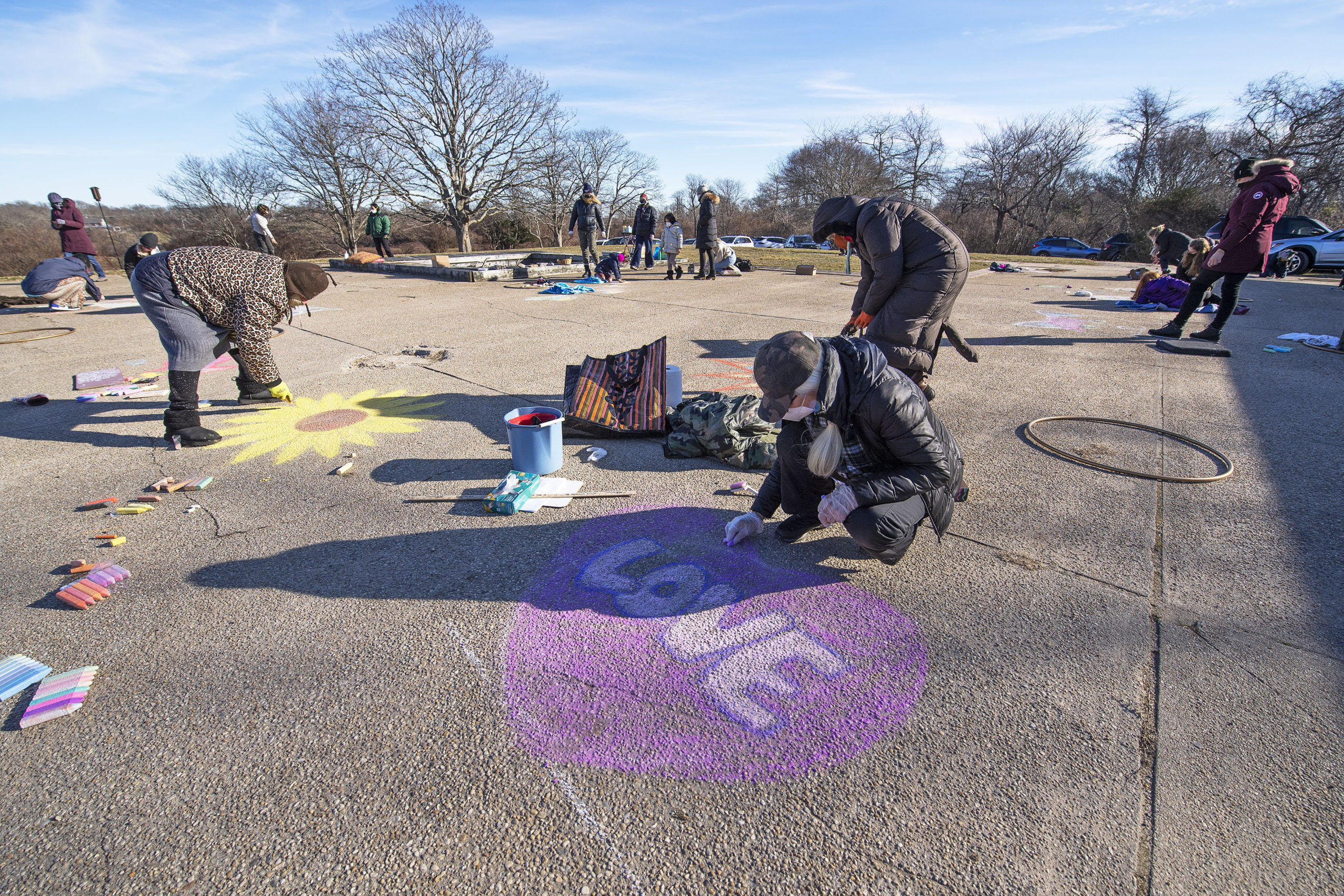 Faith Henderson puts finishing touches on her art during a chalk-drawing get-together hosted by Kate Mueth and the Neo-Political Cowgirls at the Third House grounds in Montauk on Sunday.   MICHAEL HELLER