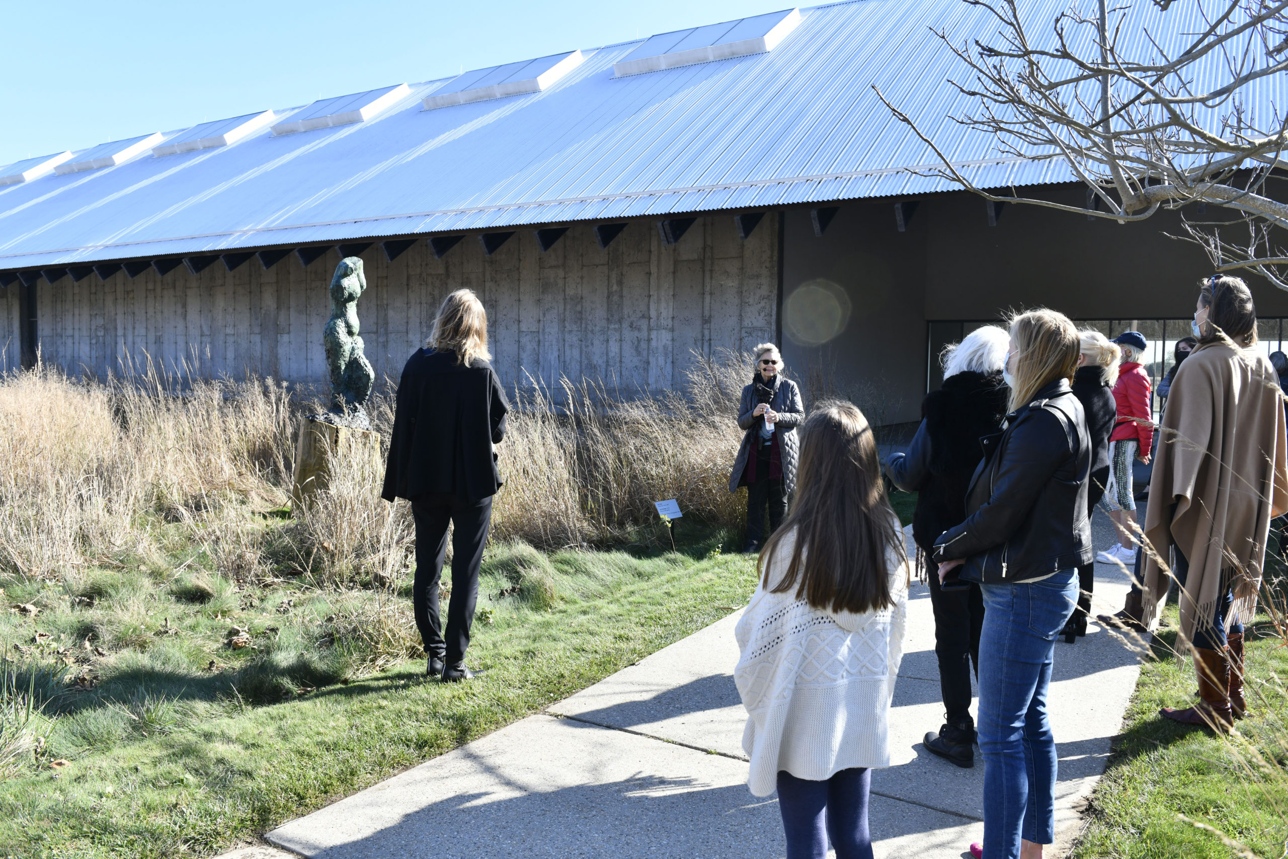 Parrish Art Museum curator Alicia Longwell takes Business Alliance members on a tour of 