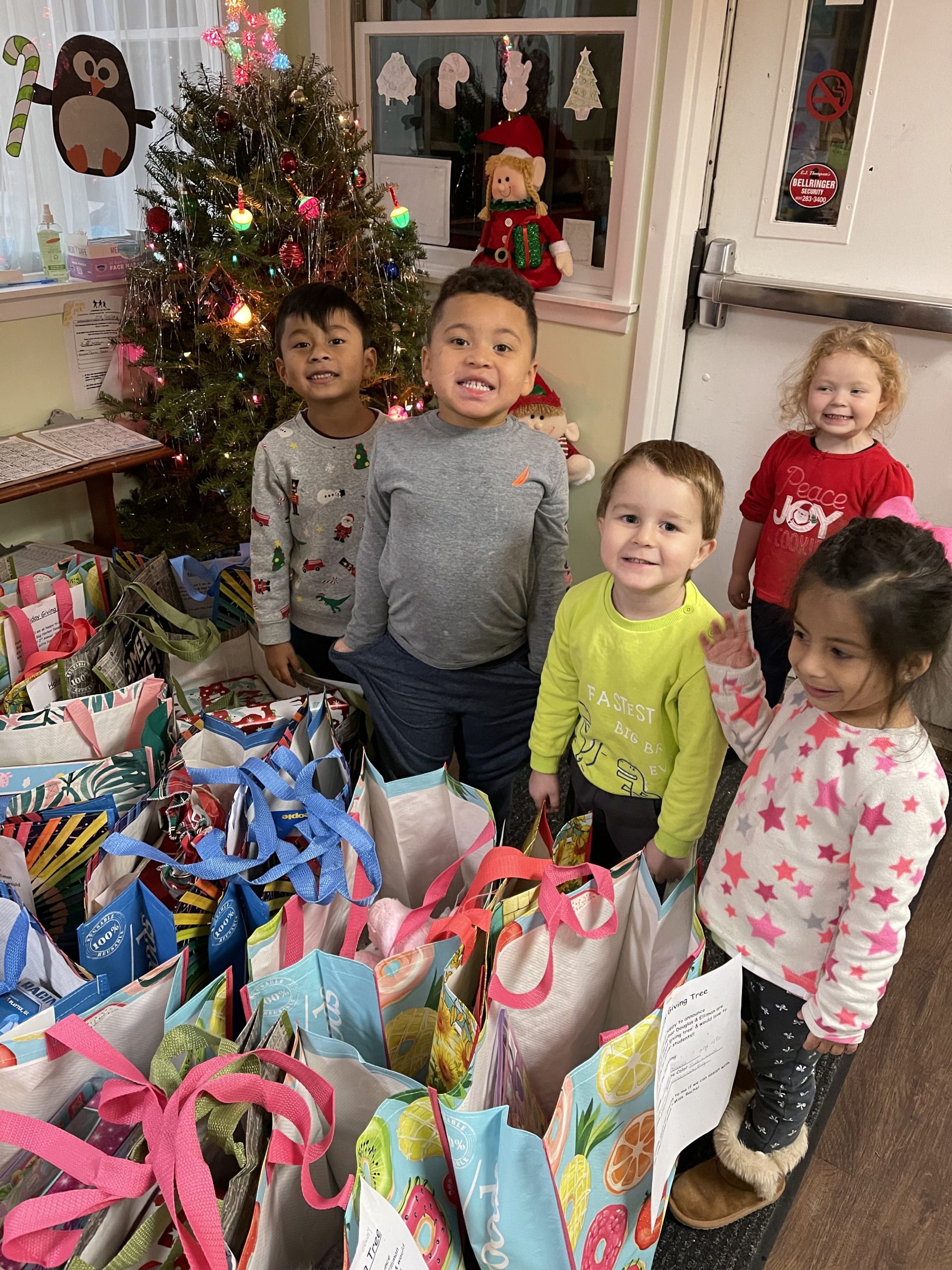 Children at the Southampton Day Care, a nonprofit day care center, receive gifts from a gift giving campaign organized by Brianna Ottati, a real estate agent at Douglas Elliman.