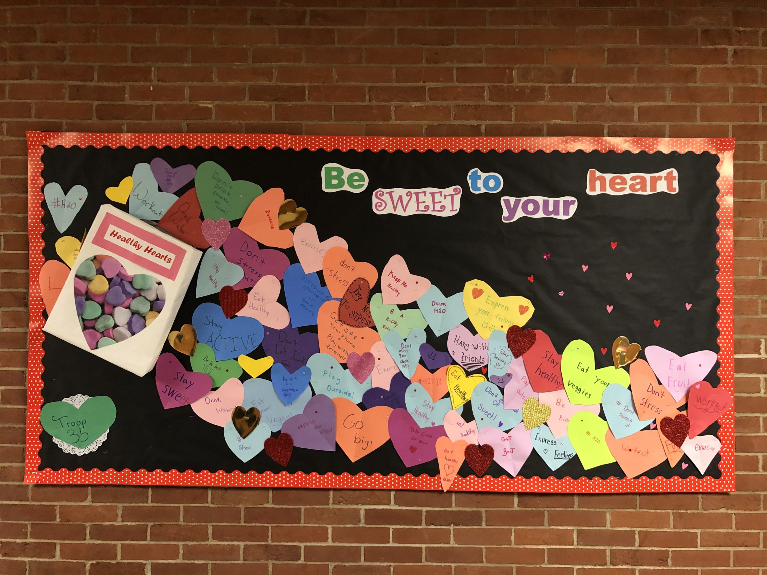 Eastport-South Manor Girl Scout Troop 35 members decorated a hallway in their elementary school with healthy heart habits as part of their Bronze Award project. Courtesy Candice Schmidt