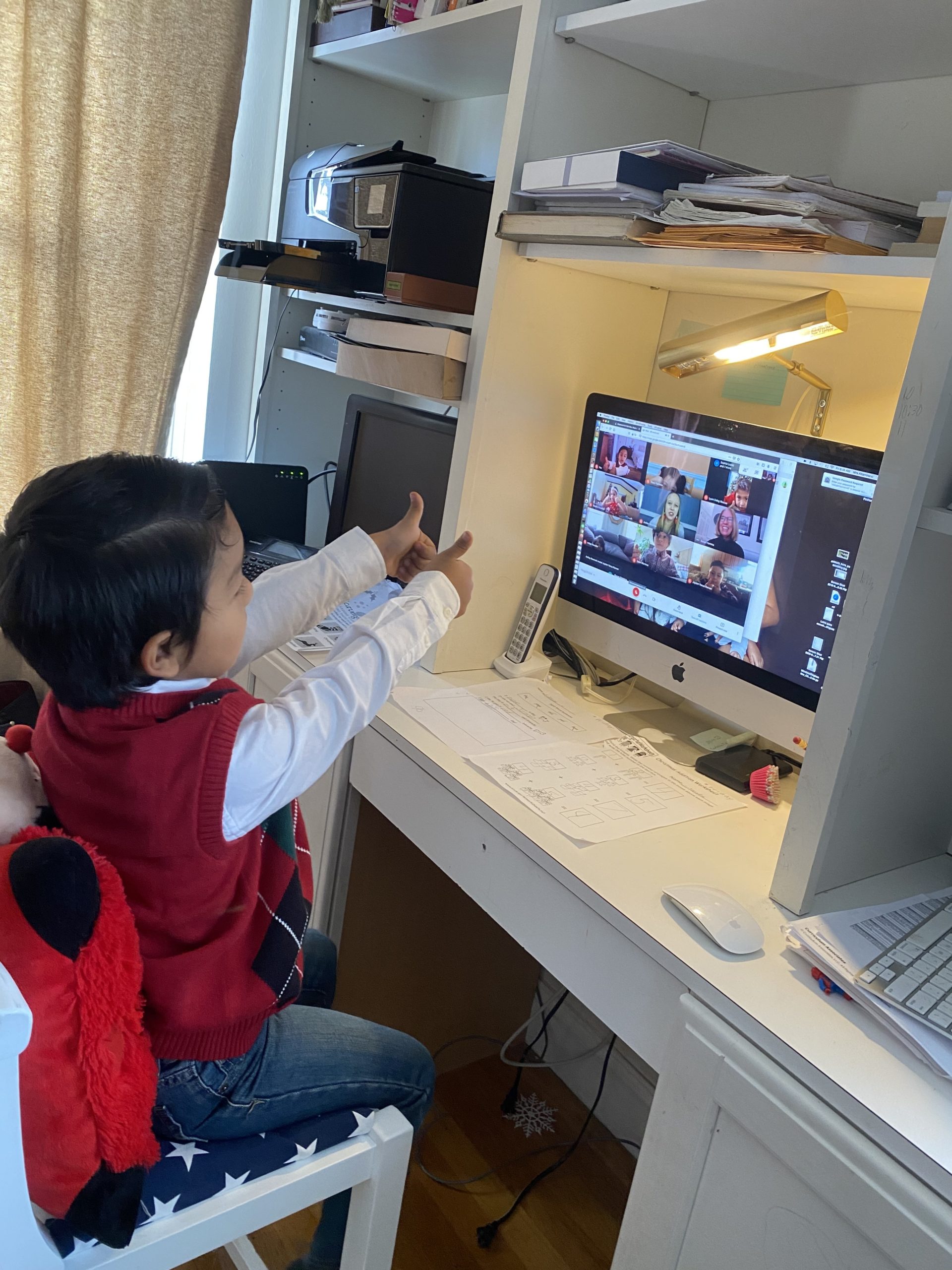 Our Lady of the Hamptons kindergartener Daniel Torres gives a thumbs up to his teachers during a virtual learning session last week.