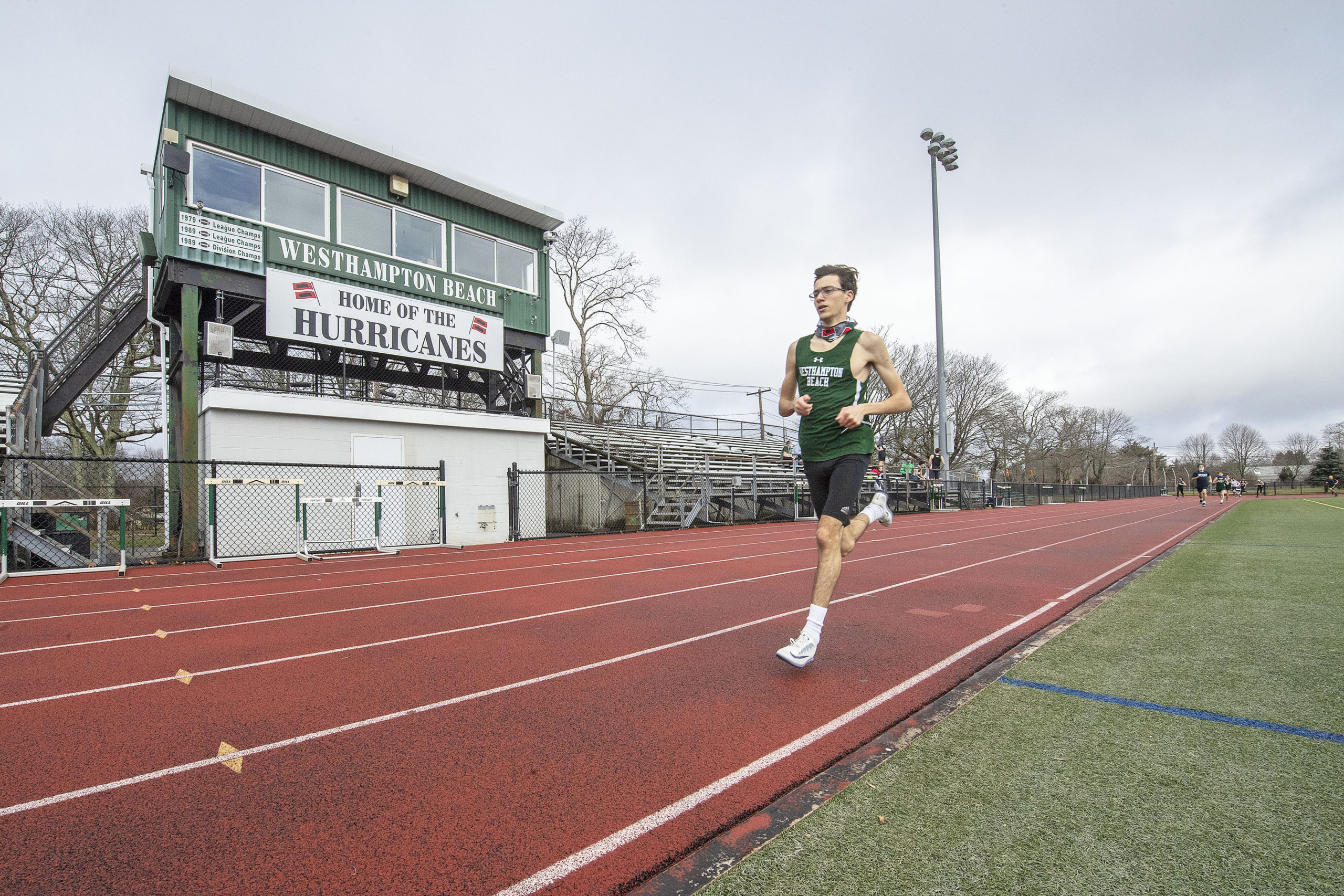 Gavin Ehlers leads the field by a large margin during the 1600 meter race as the Westhampton Beach boys track team competes against the team from Rocky Point at Westhampton Beach High School on Saturday.       MICHAEL HELLER