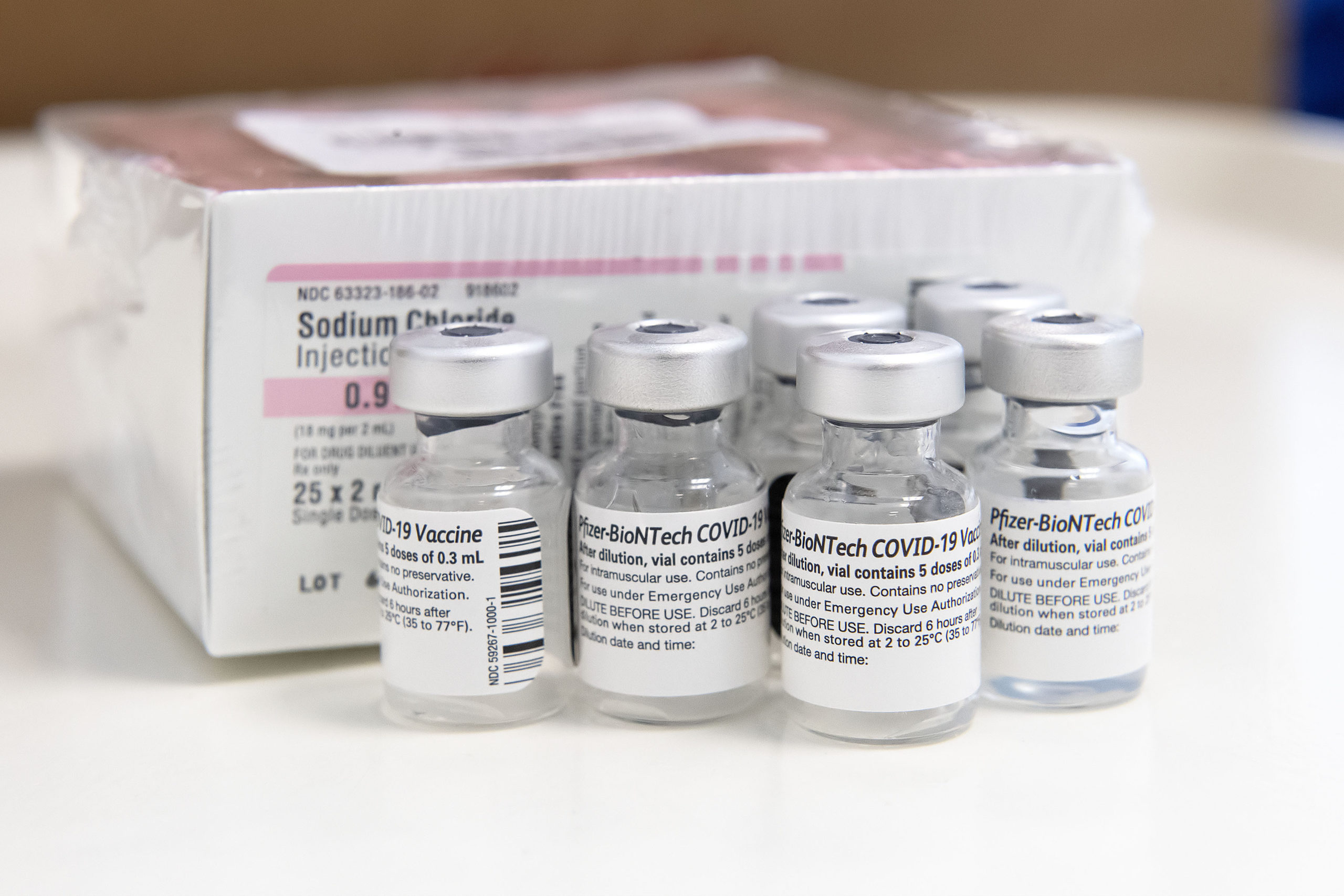 Used bottles of the Pfizer COVID-19 vaccine and their Sodium Chloride diffuser during a vaccination session held at the former Child Development Center of the Hamptons facility on Stephen Hands Path in East Hampton on Saturday afternoon.      MICHAEL HELLER