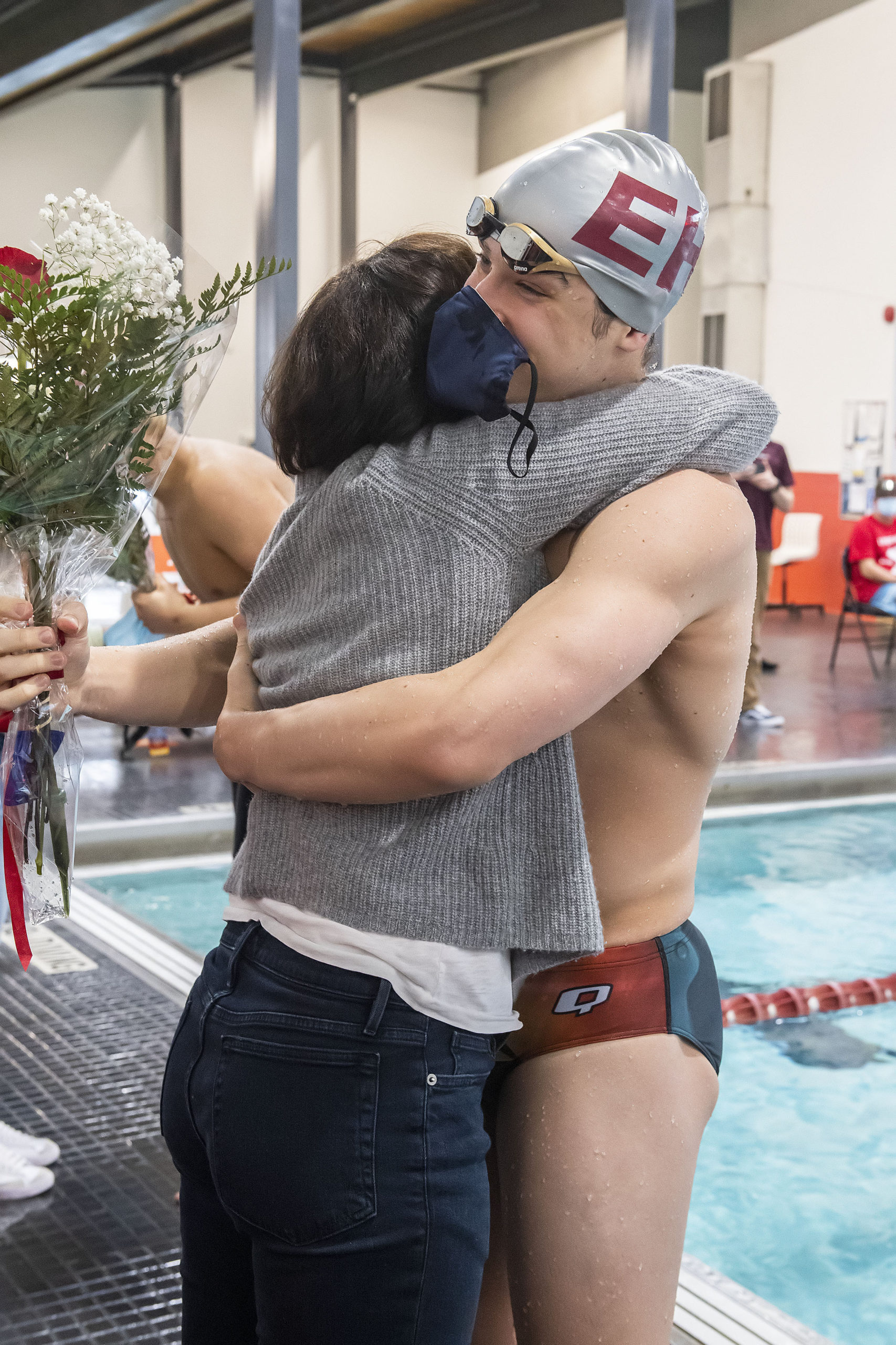 East Hampton's Colin Harrison competes in the 200-yard individual medley during the Bonackers' meet against Lindenhurst on Friday. MICHAEL HELLER|Harrison gets a big hug from his mom Stephanie during a Senior Day ceremony prior to the East Hampton Bonackers' Boys Swim Team meet against Lindenhurst at the East Hampton Rec Center on Friday.    MICHAEL HELLER