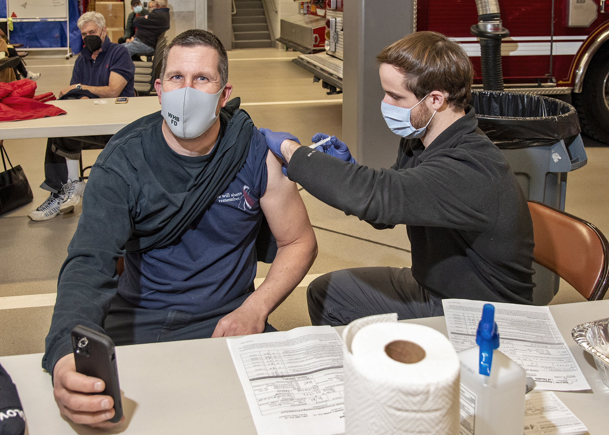 Captain Tom Glover of the Westhampton Beach Fire Department gets his first dose of the Moderna vaccine from Barths pharmacist Conor Cassara, PharmD.      Courtesy Westhampton Beach Fire Department