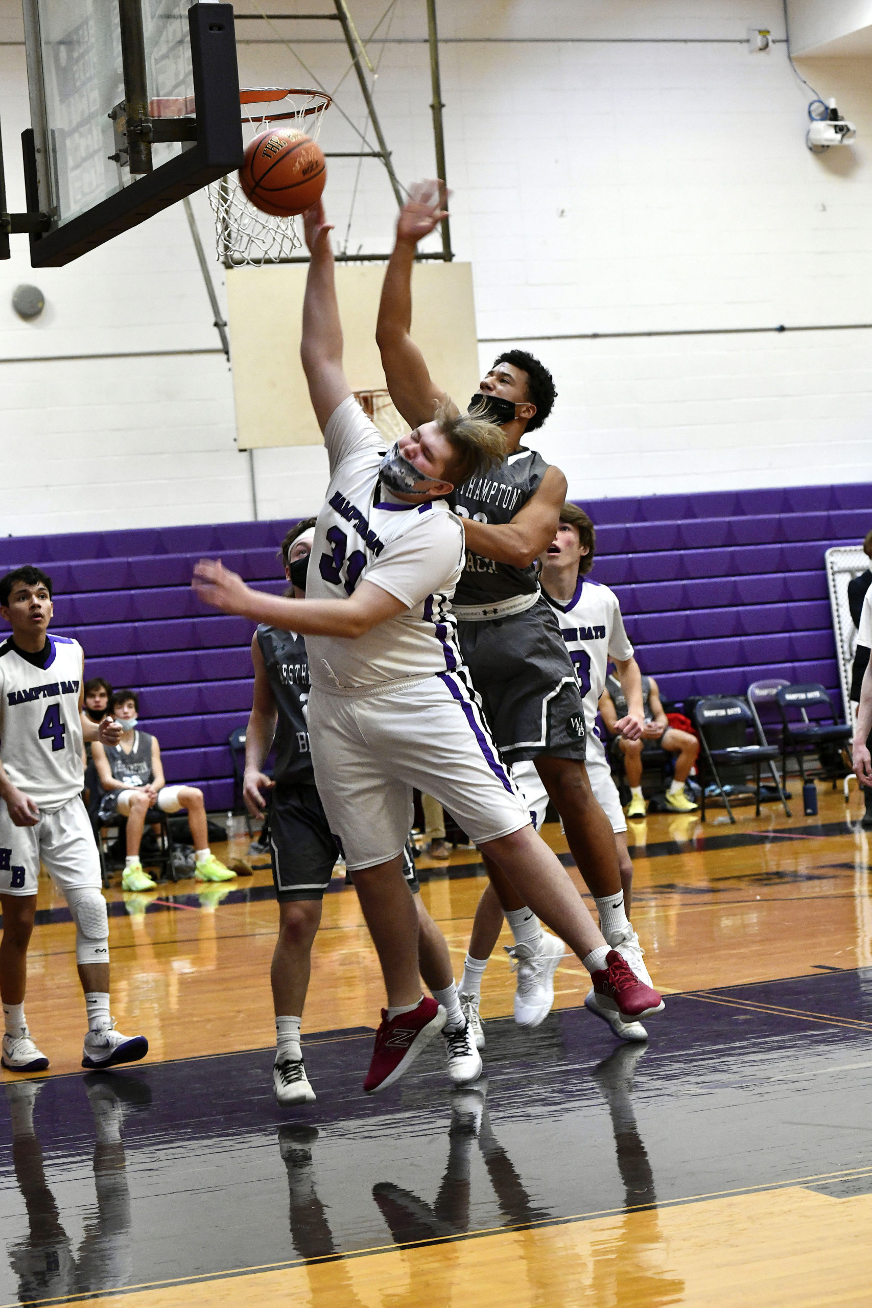 Hampton Bays eighth-grader Cole Wilson reaches for the rebound ahead of Westhampton Beach's Mickey Giacchetto.         DANA SHAW