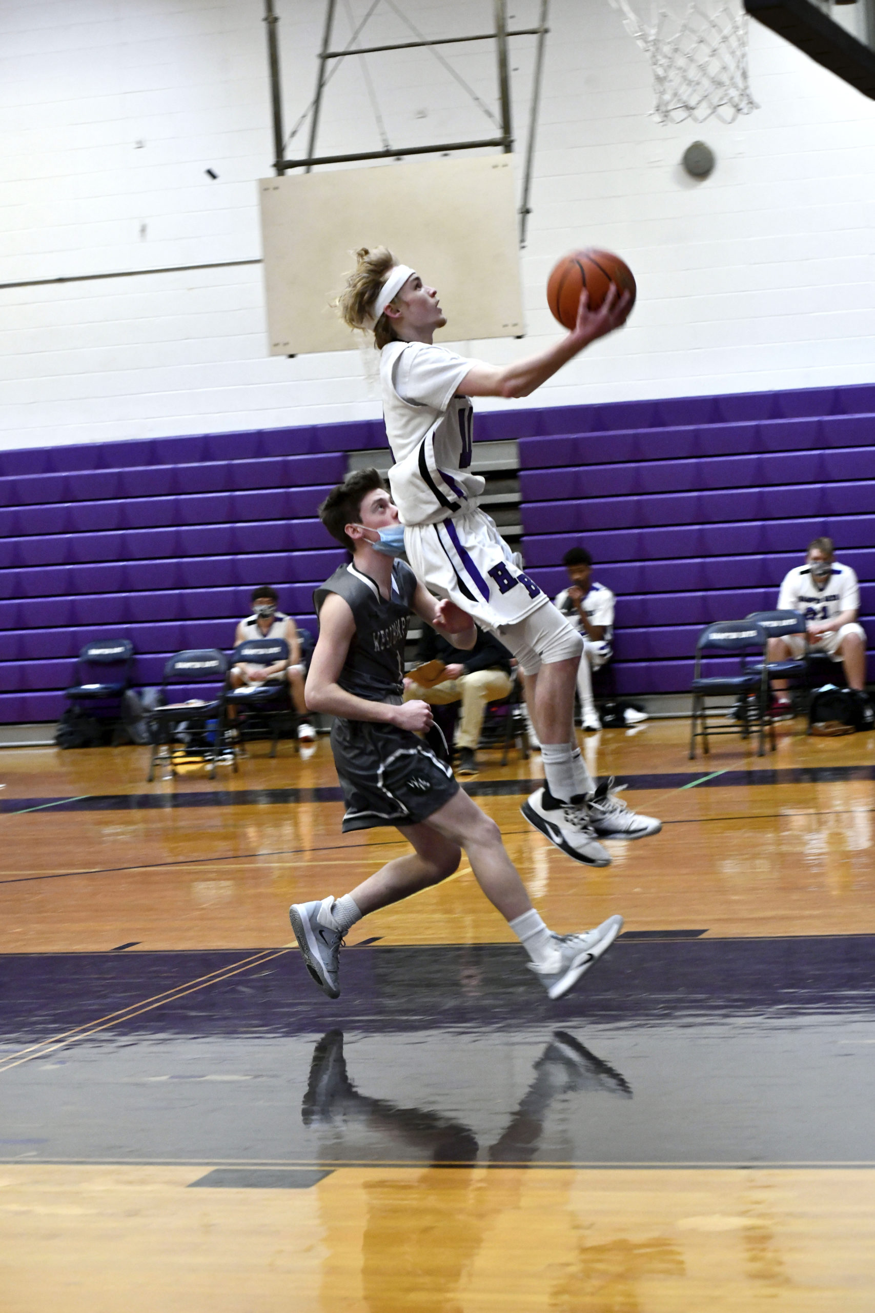 Hampton Bays senior point guard Jack McNamara goes for a layup ahead of Westhampton Beach's Lou Hagopiam.     DANA SHAW