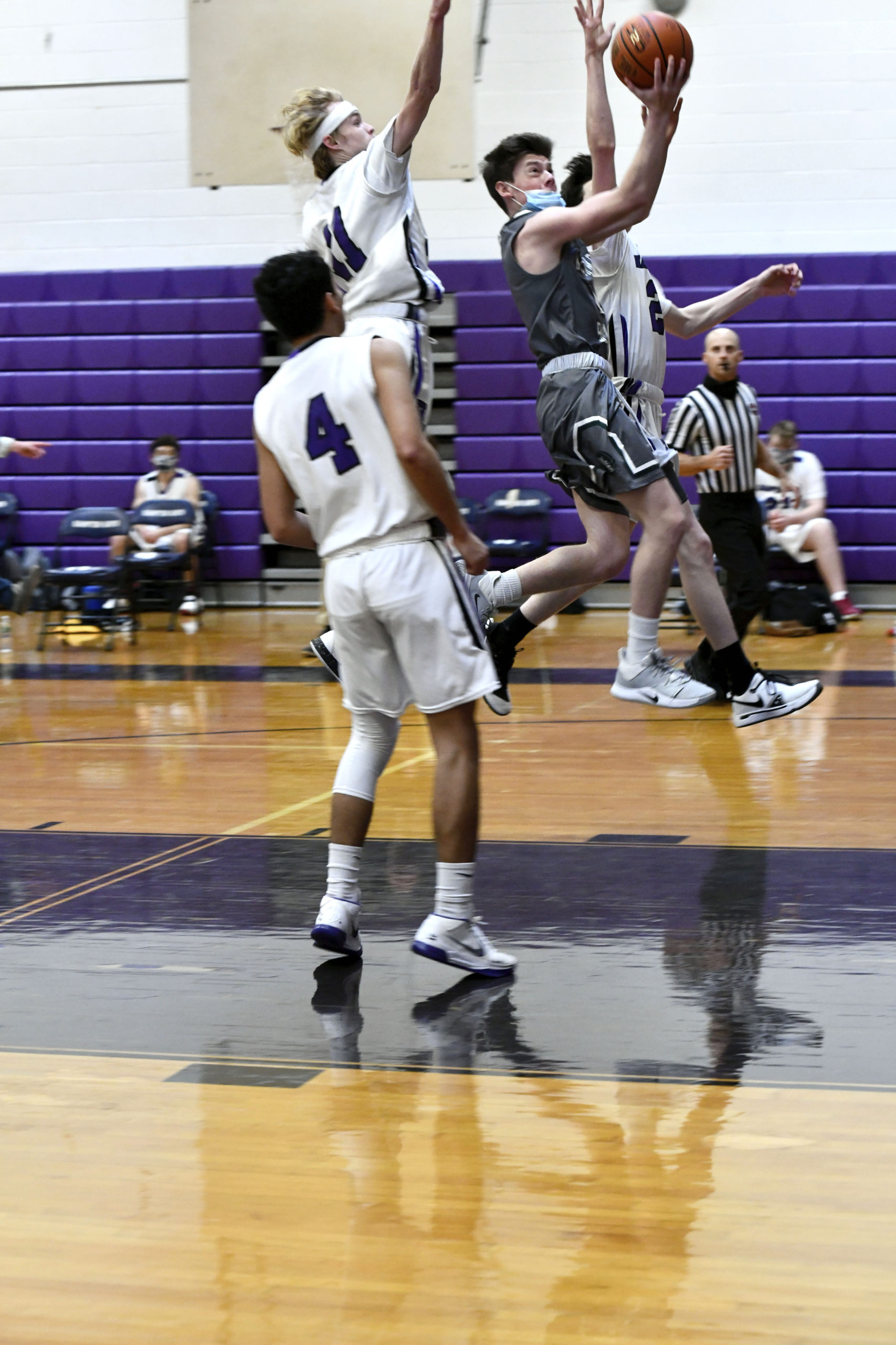 Westhampton Beach senior point guard Lou Hagopian scores on a layup between Hampton Bays' James Salas, Jack McNamara and Nick Alvarez. DANA SHAW