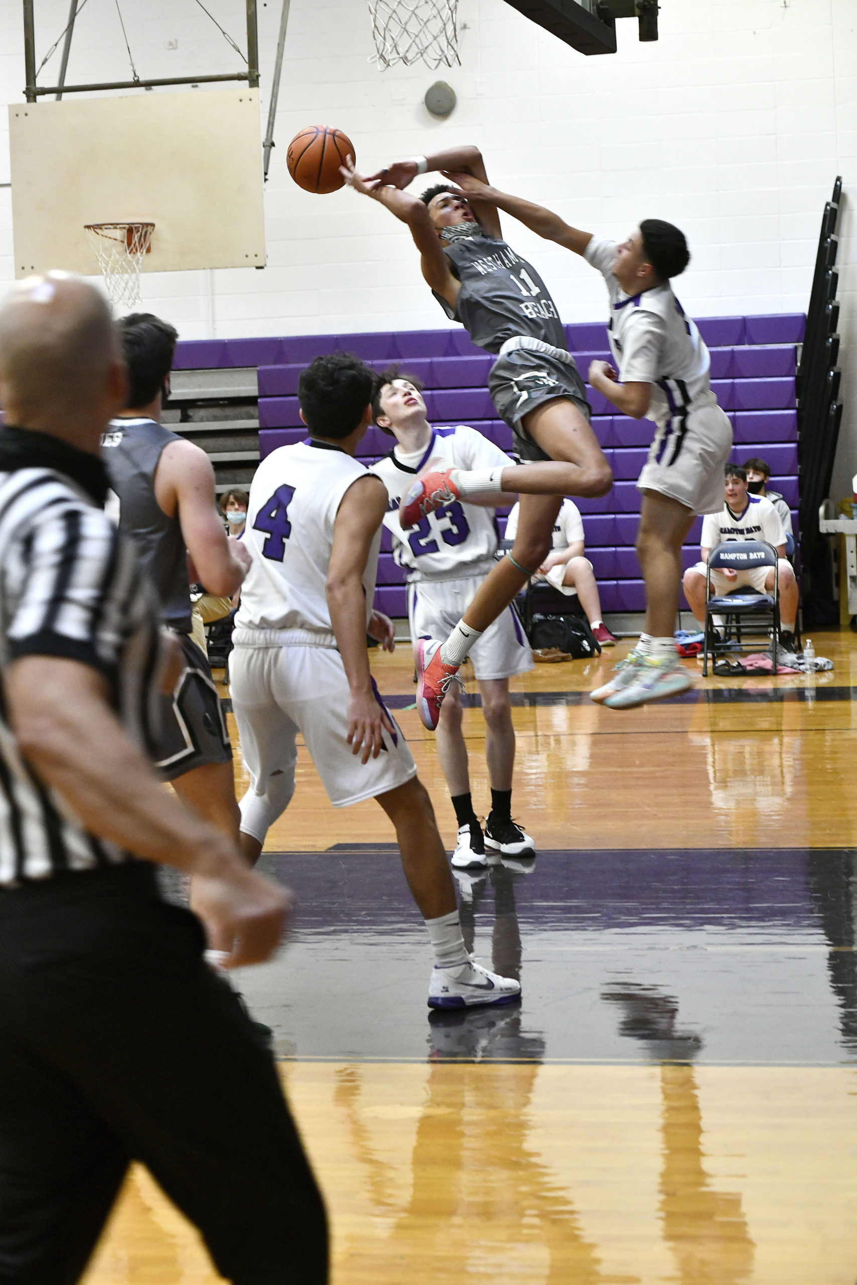 Westhampton Beach junior forward Cameron DePetris attempts to shoot over a block by Hampton Bays senior Nick Alvarez.                  
DANA SHAW