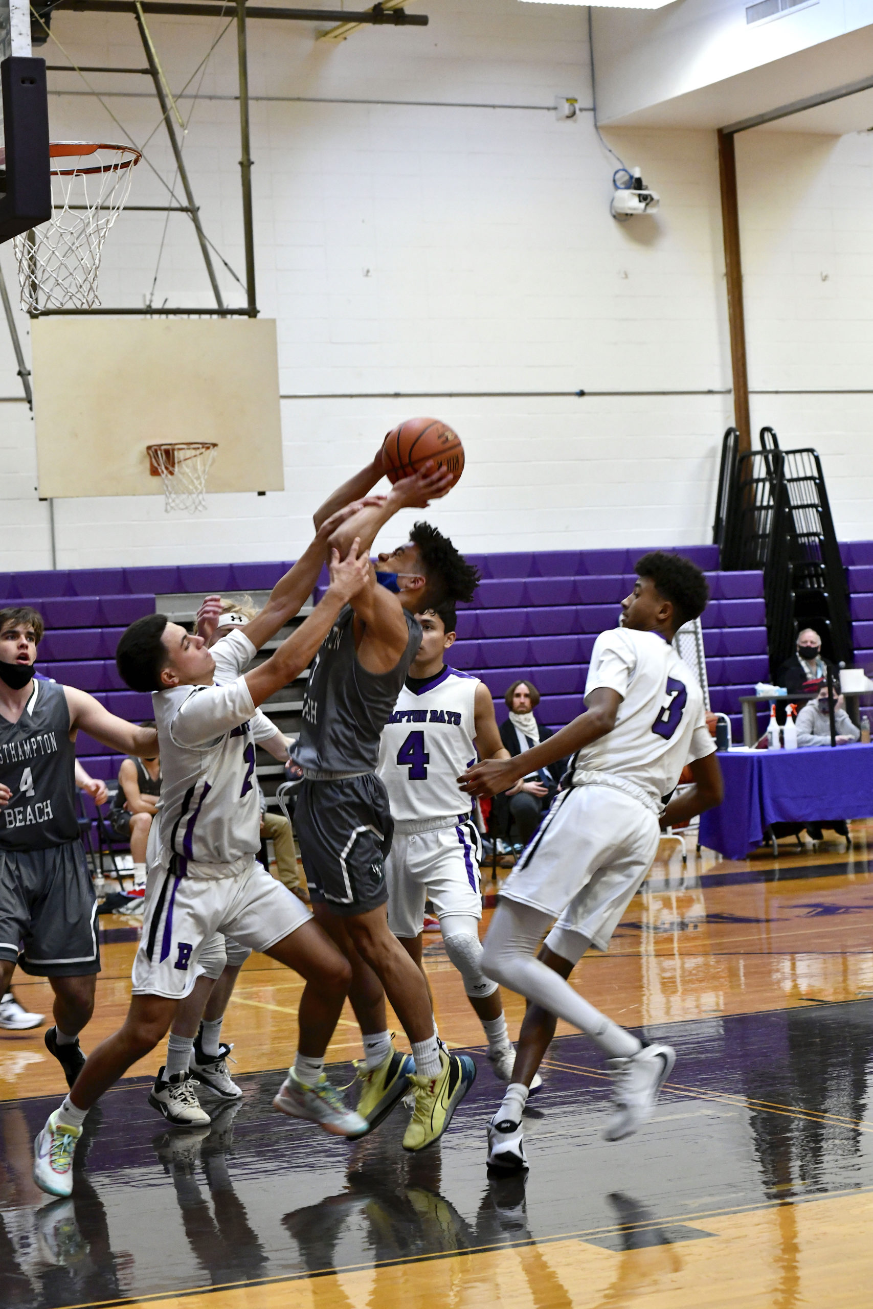 Westhampton Beach senior Justice Goode is fouled by Hampton Bays senior Nick Alvarez. DANA SHAW