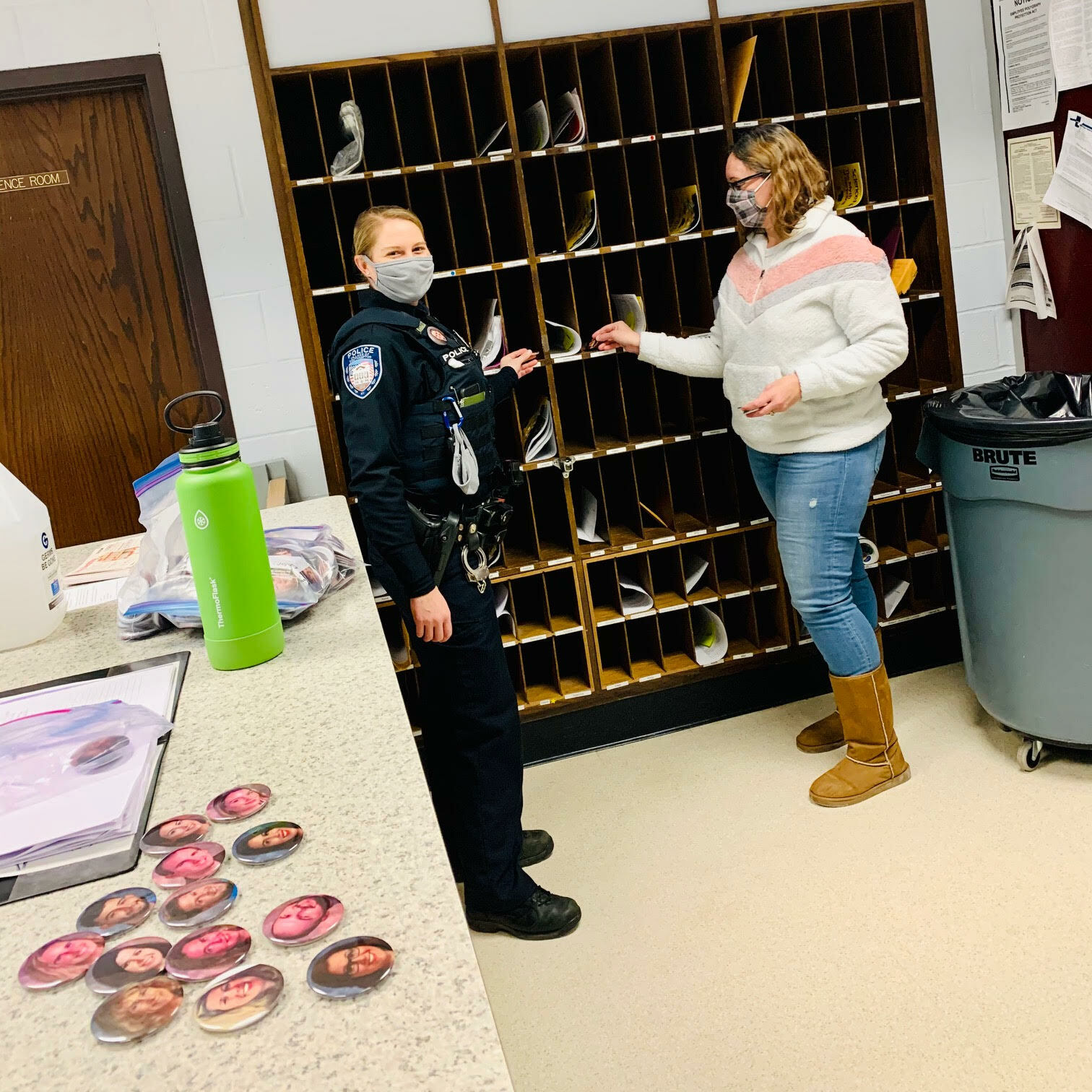Officer Lisa McCulley and main office secretary Amy Davis also putting faculty buttons in mailboxes.