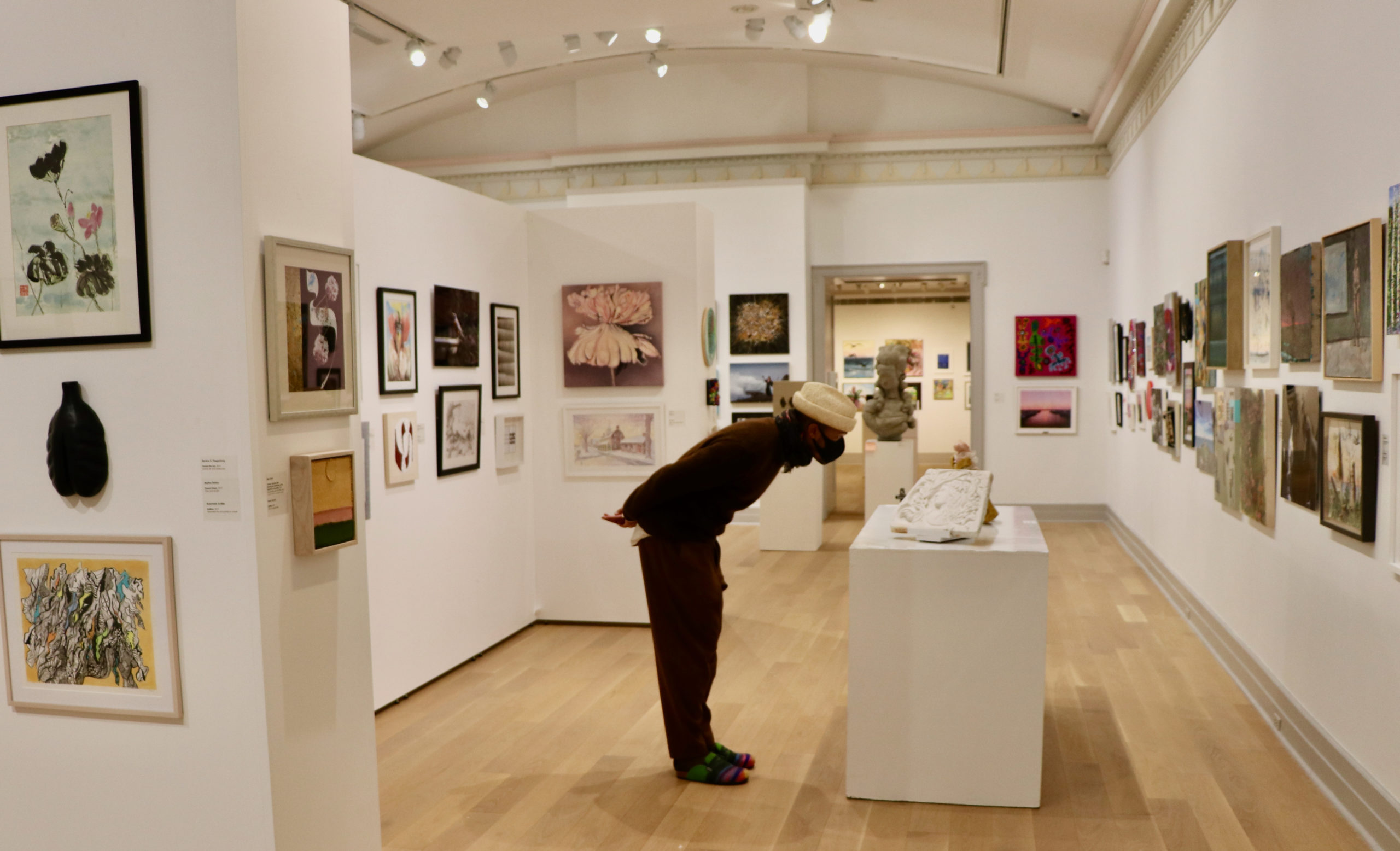 Judge Antwaun Sargent looking at artwork for the 83rd Artist Members Exhibition at Guild Hall.