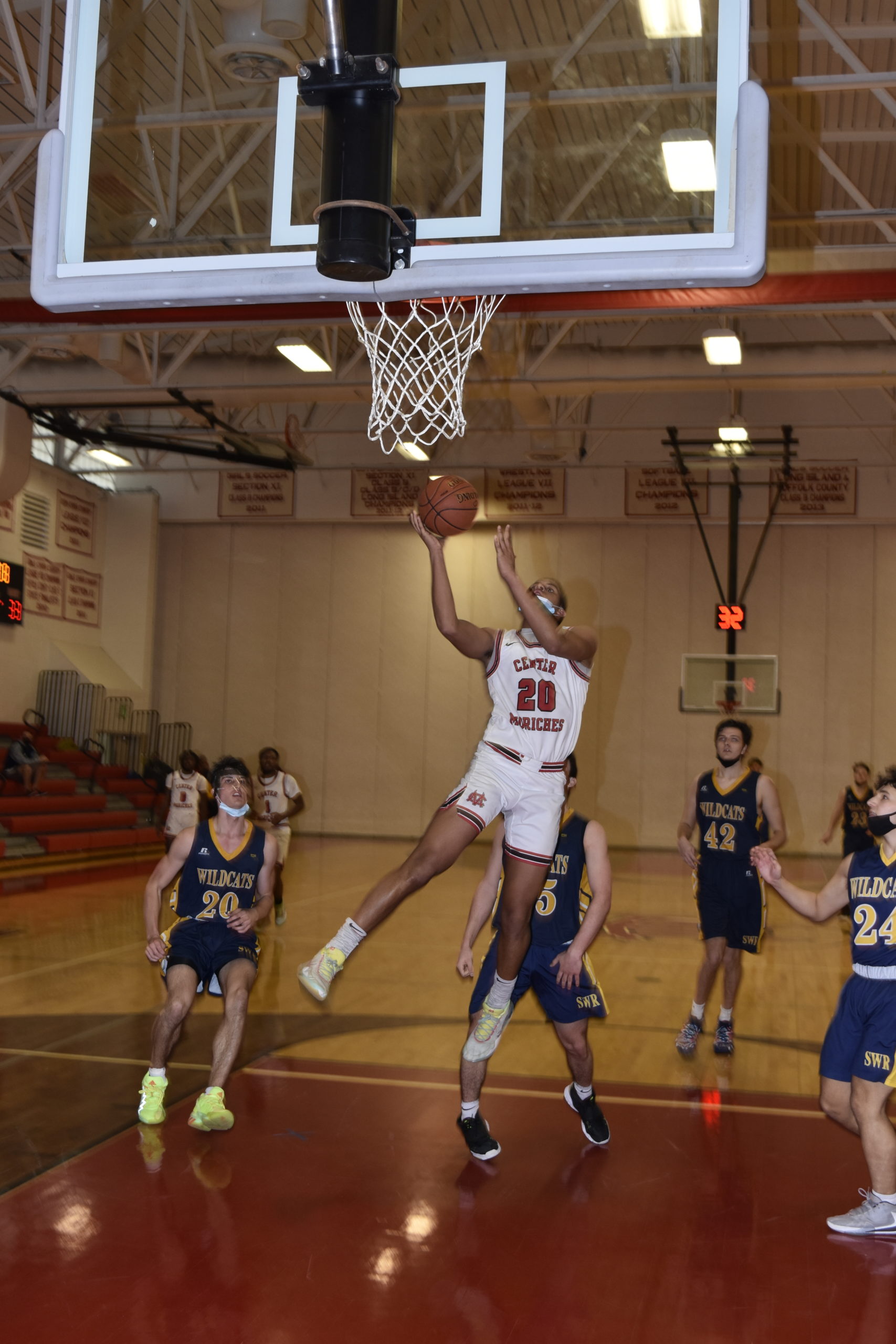 Center Moriches senior Jaden Kealey finishes off a fast break for two of his 14 points.