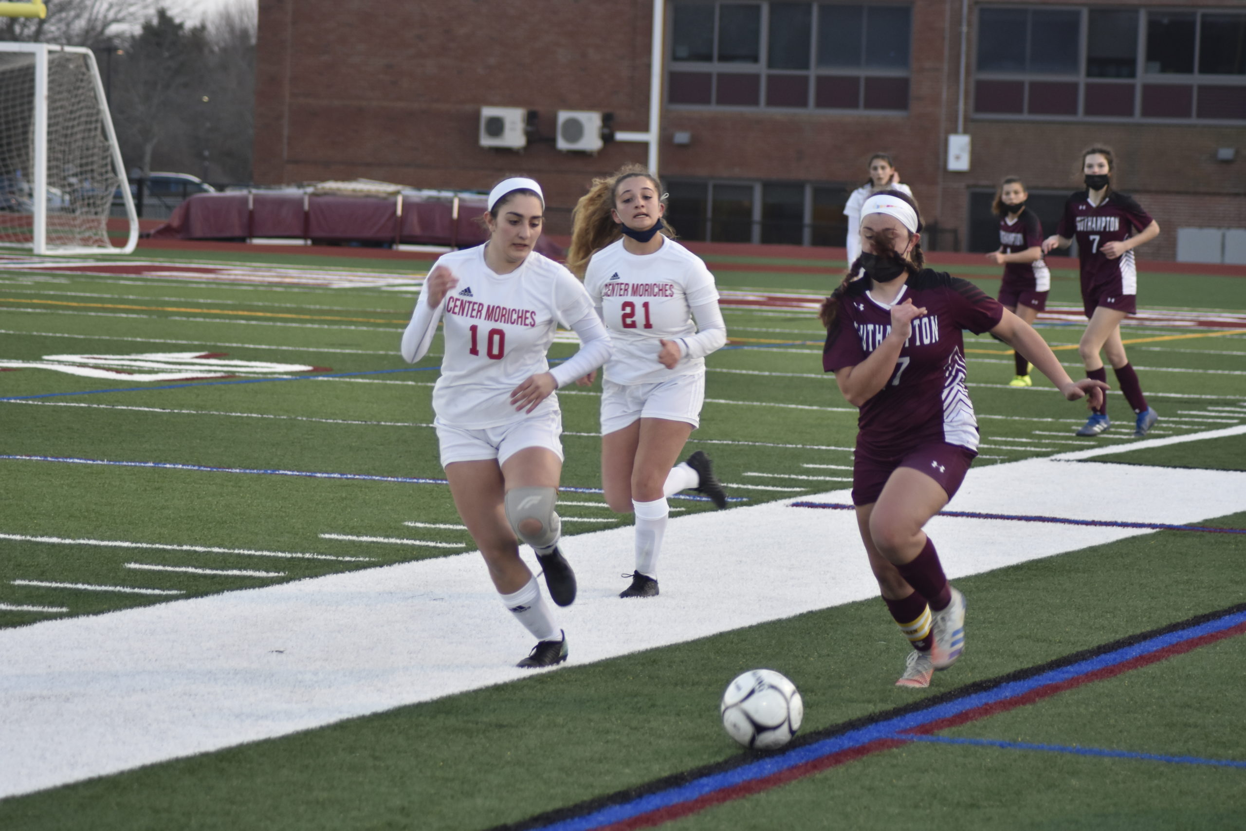 Southampton junior co-captain Ellie Avallone races a Center Moriches player down the sideline for a loose ball.