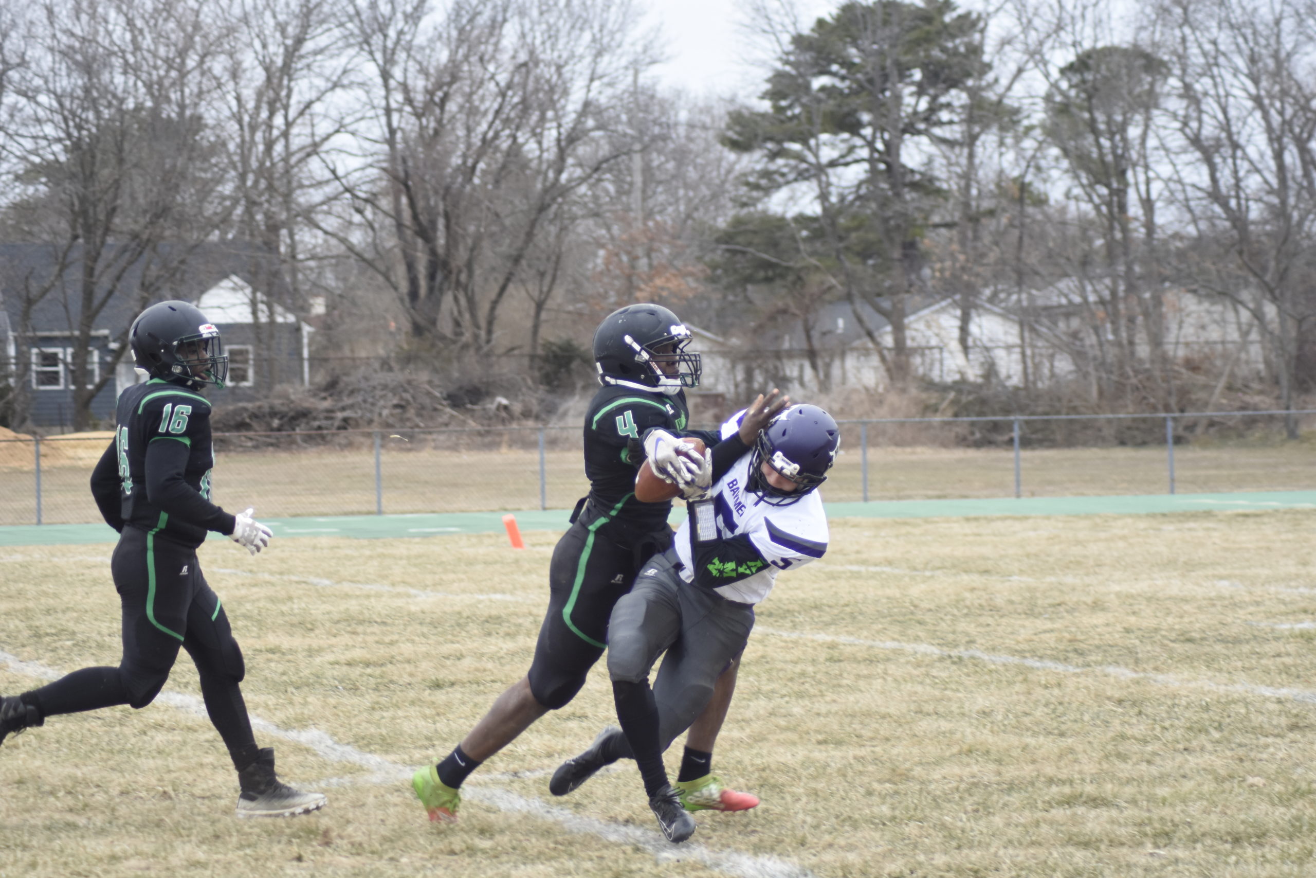 Hampton Bays senior receiver Mickey Bracken makes a catch over Wyandanch senior DeAndre Smith.