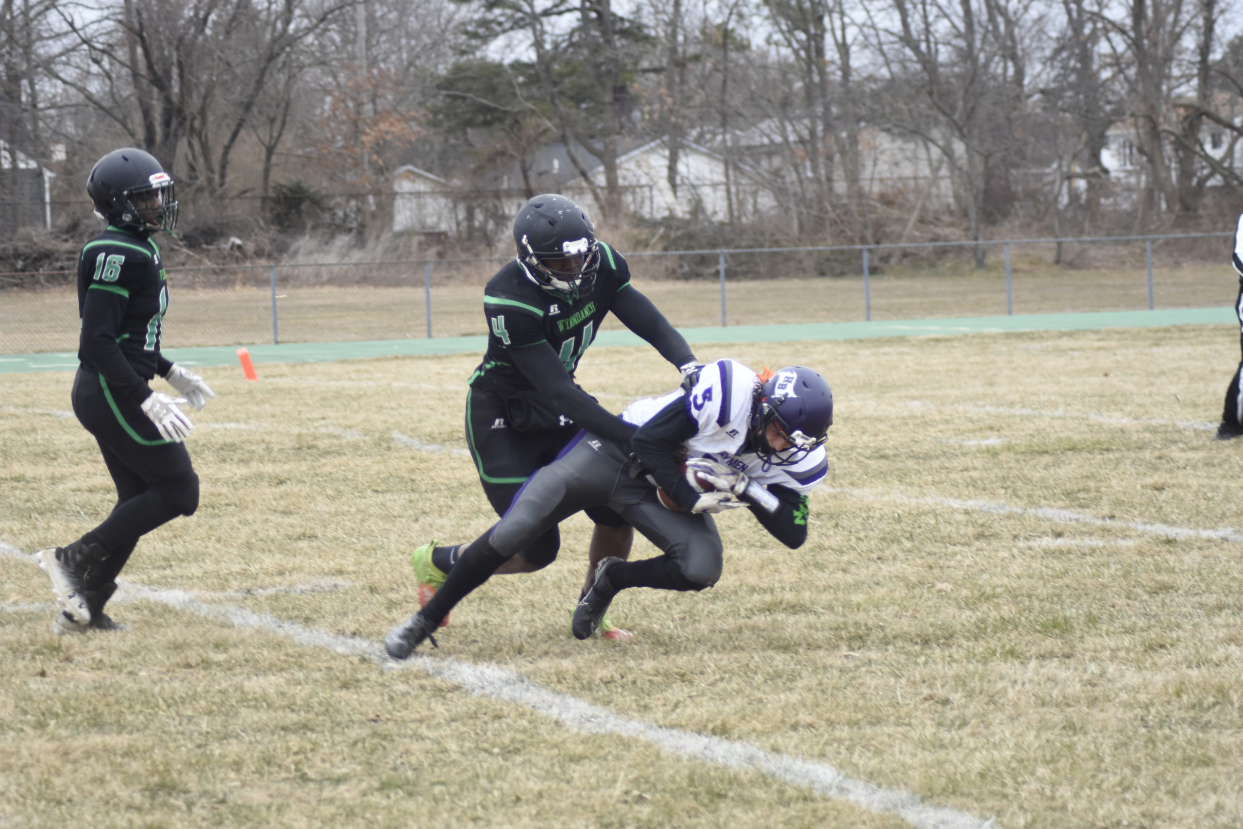 Hampton Bays senior receiver Mickey Bracken makes a catch over Wyandanch senior DeAndre Smith.