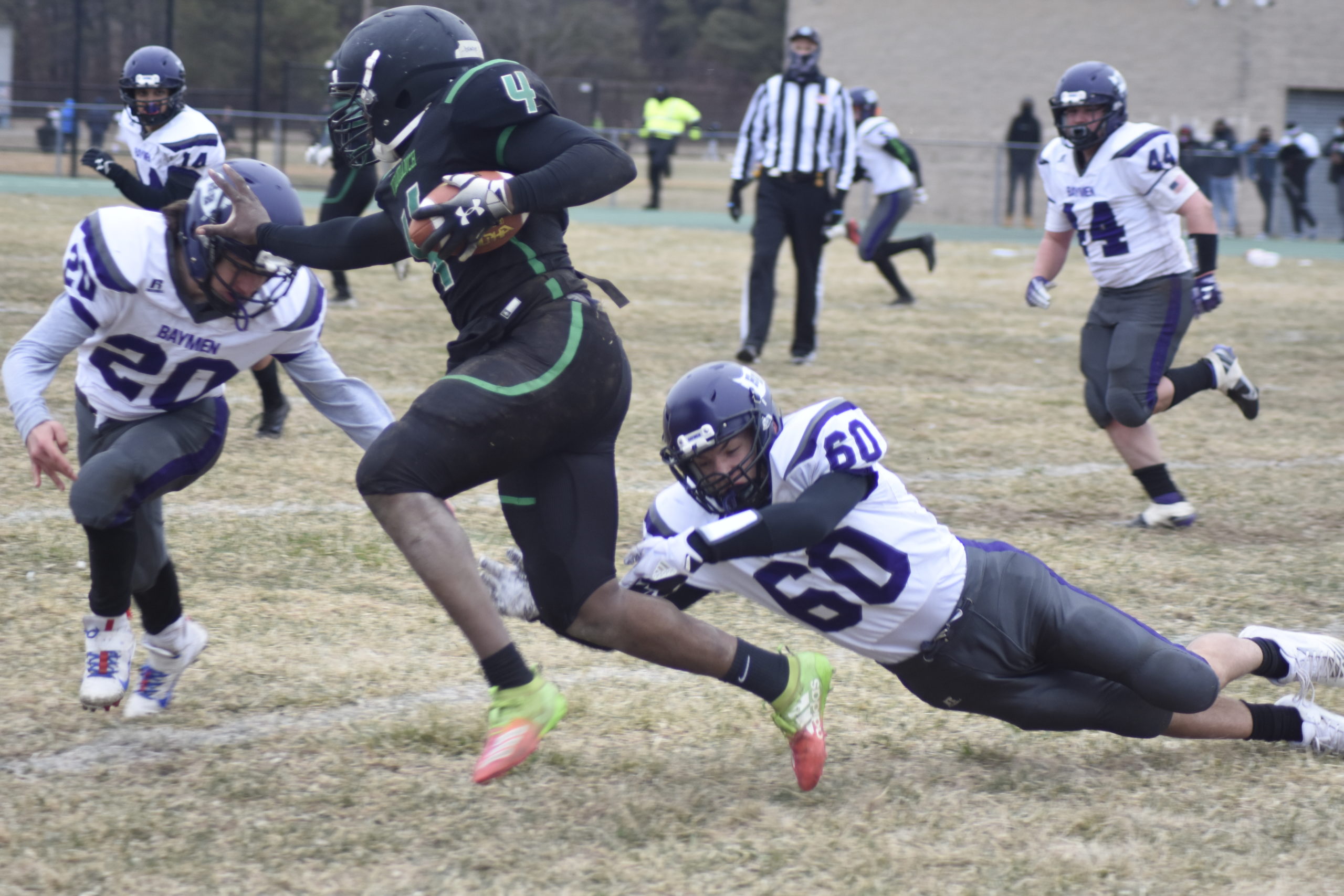 Baymen Will Krivickas and Kevin Sohtz get to Wyandanch quarterback DeAndre Smith.