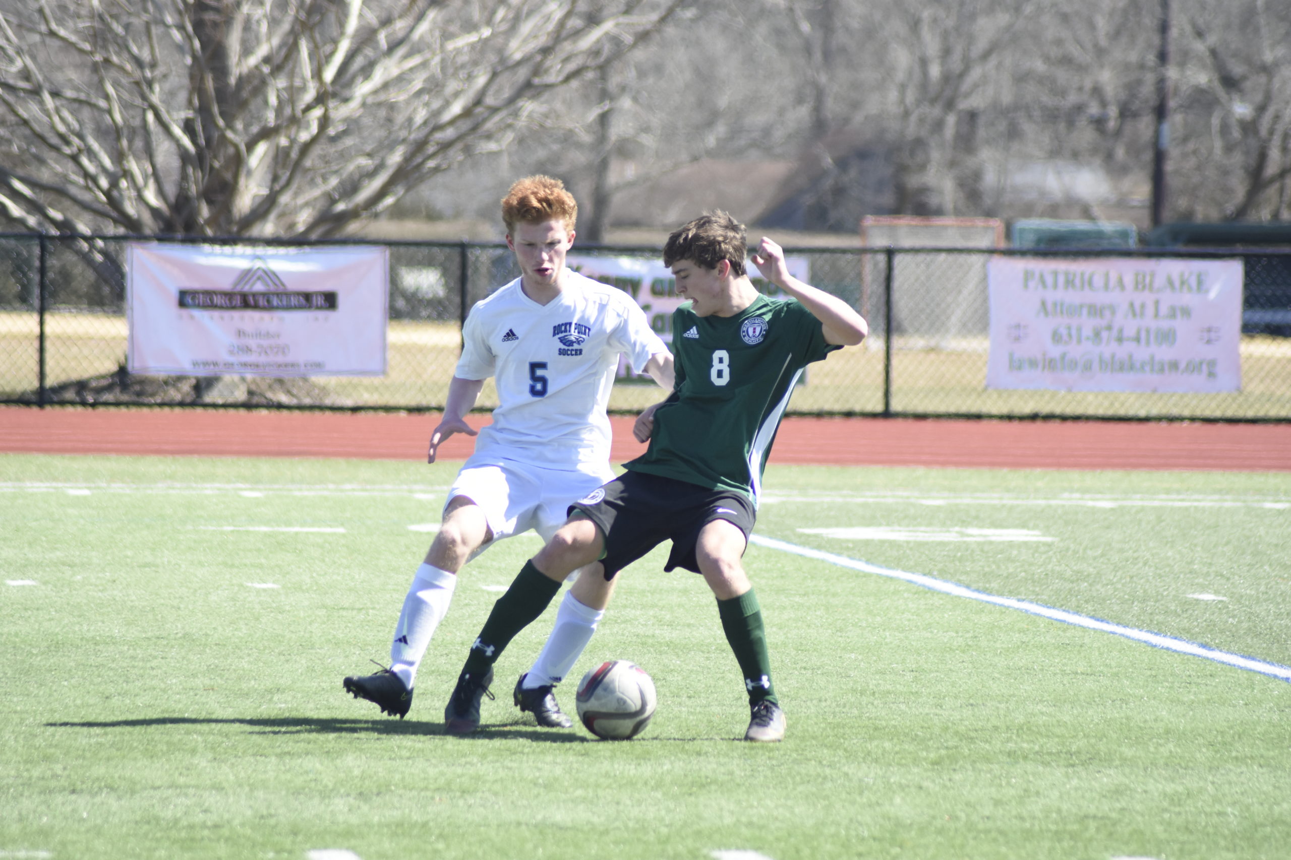 Westhampton Beach senior Santo Benenati fends off a Rocky Point player.