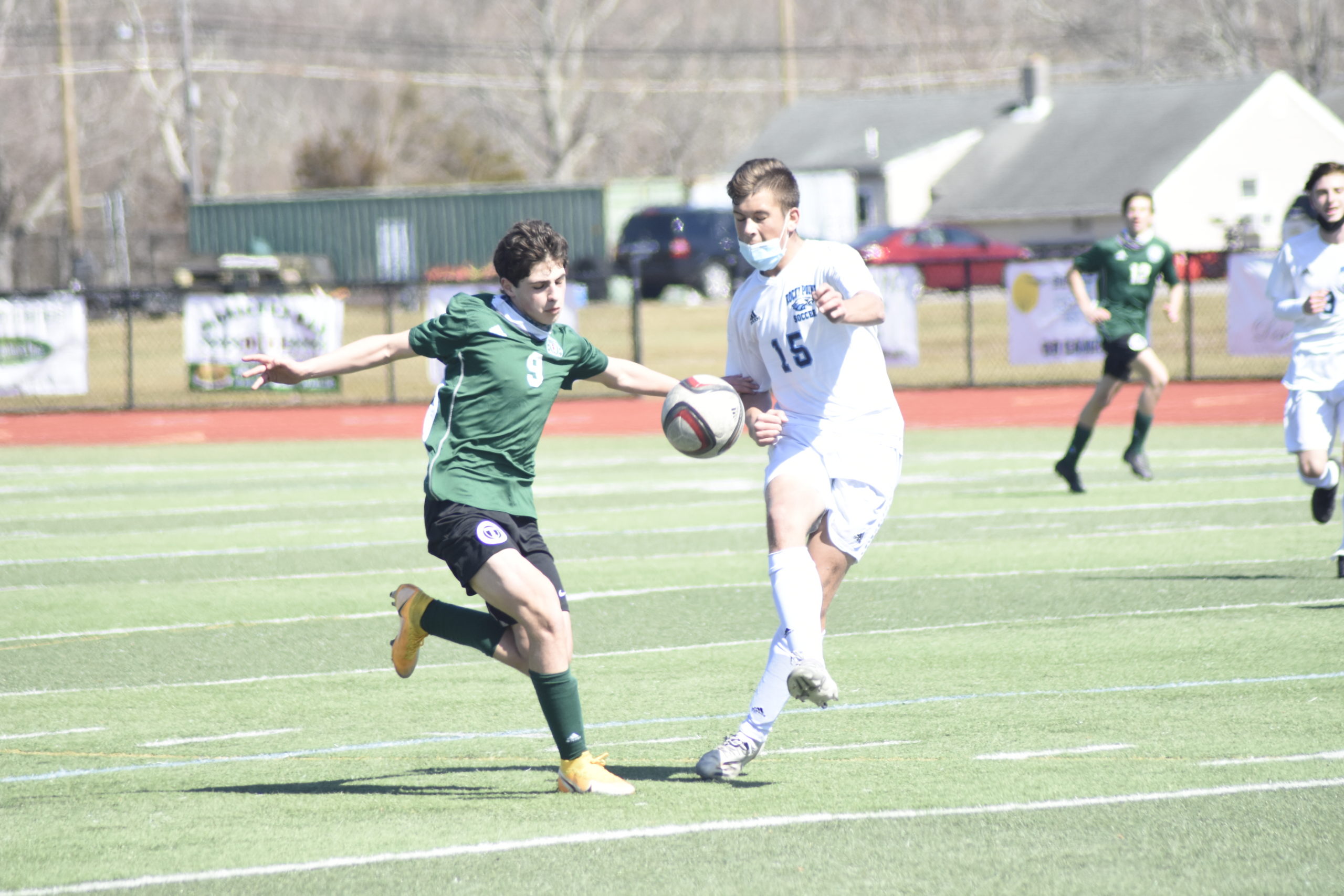 Westhampton Beach junior Loris Van Vlodrop and a Rocky Point player go after a bouncing ball.