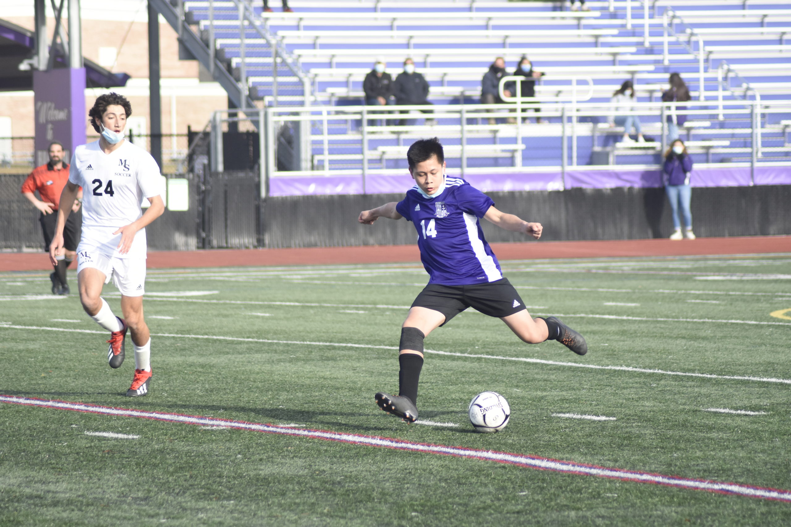 Hampton Bays junior John Pacheco gears up to boot the ball.