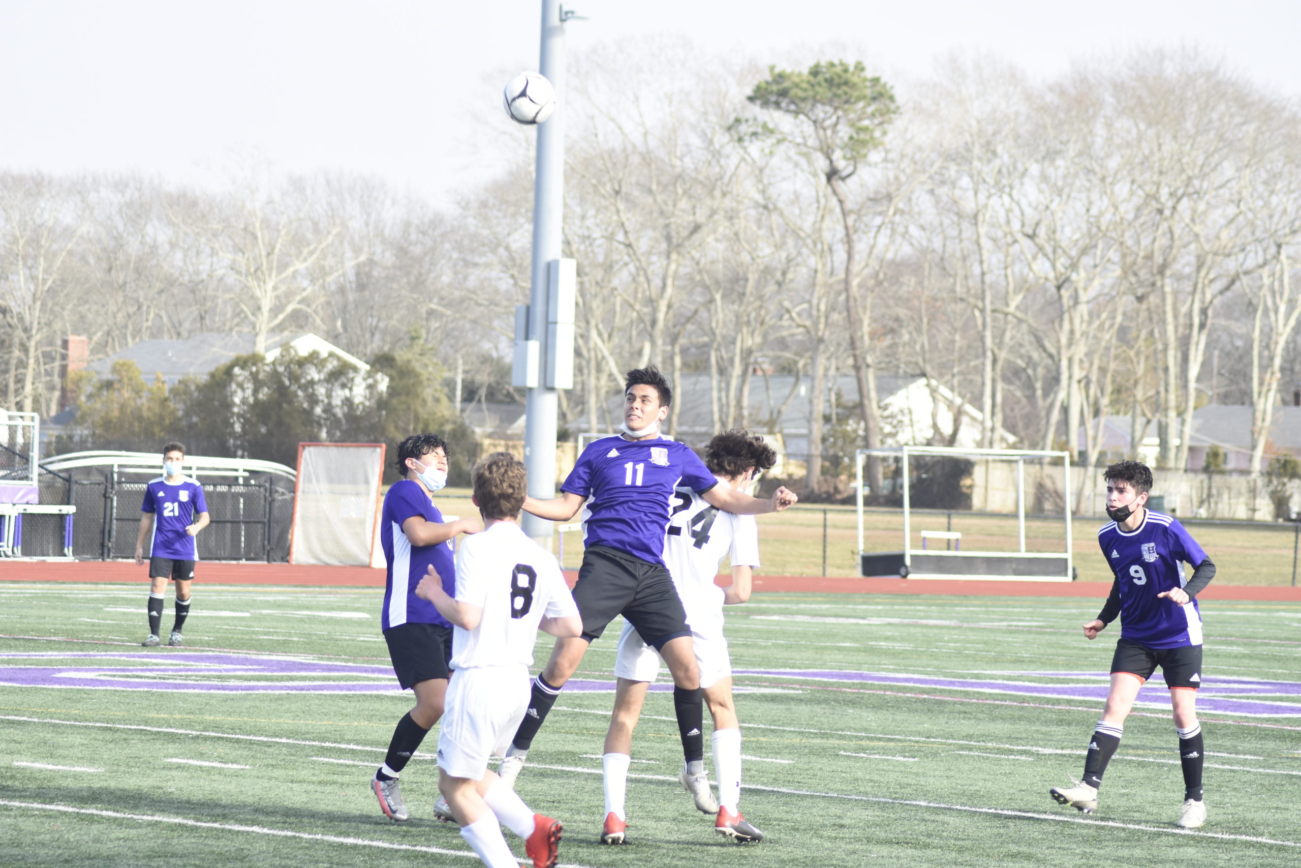 Junior Bayman Juan Alape heads the ball.