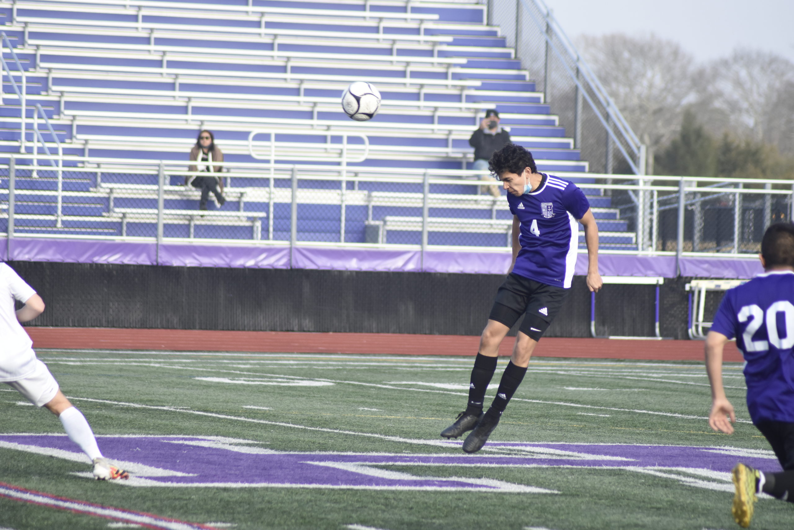 Junior Juan Salas heads the ball back out of the Baymen's defensive end.