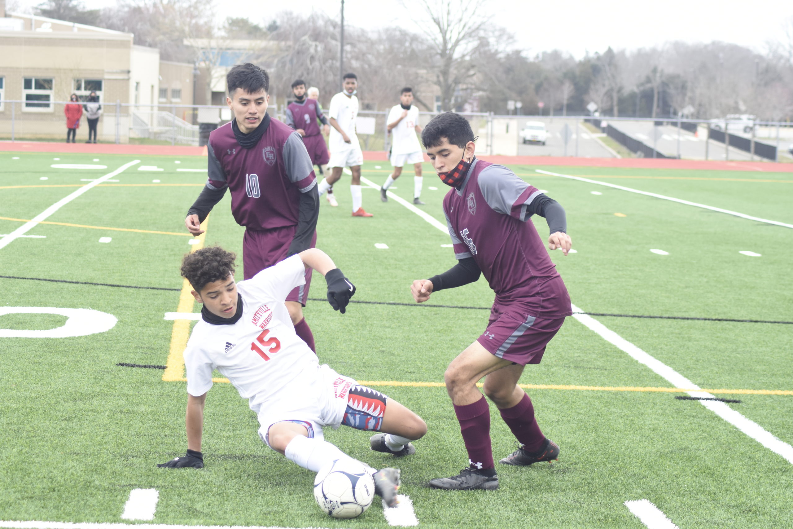 Bonackers Christopher Pintado (10) and Michael Ortiz cover an Amityville player who drew a foul on the play.